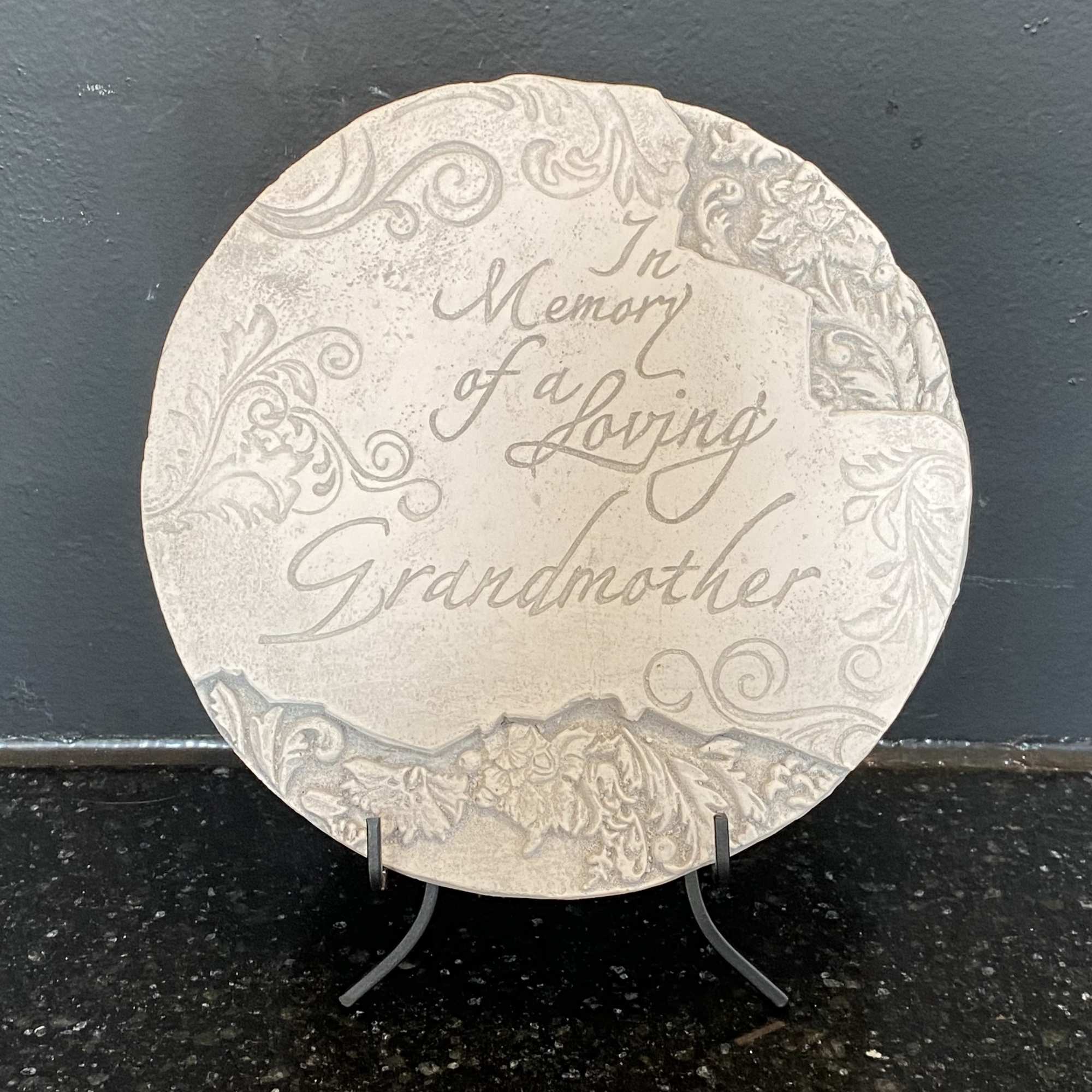 Decorative memorial plaque on a stand with the words "In Memory of a Loving Grandmother"