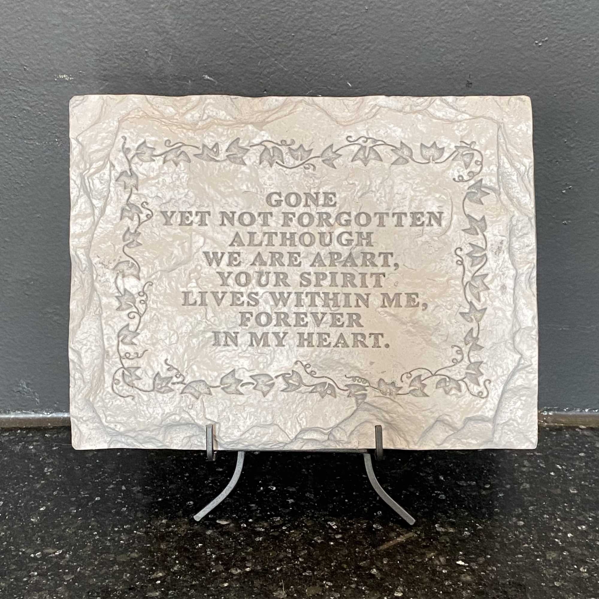 Memorial plaque with an engraved remembrance message on a stand