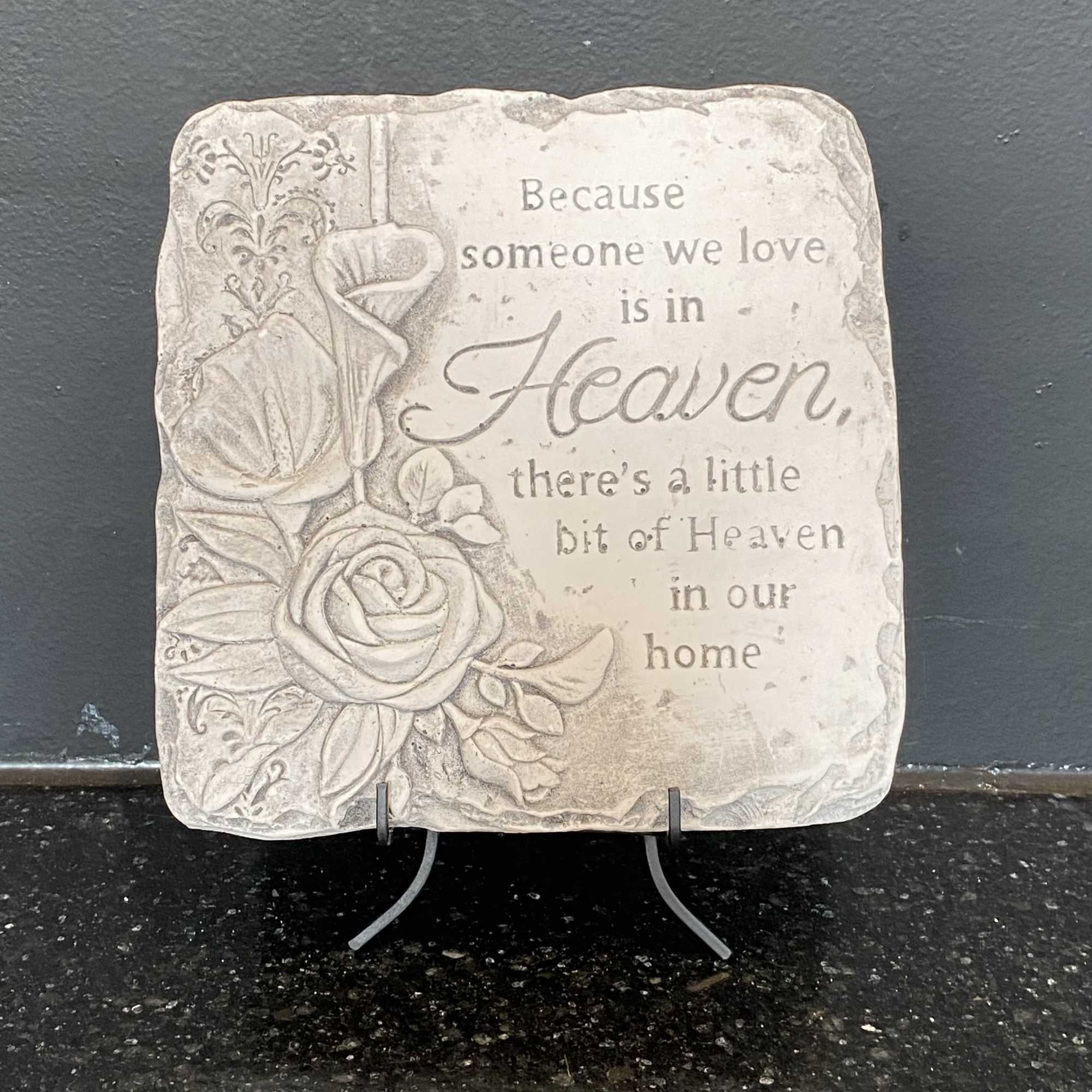 Decorative memorial plaque with floral relief and a sympathy quote