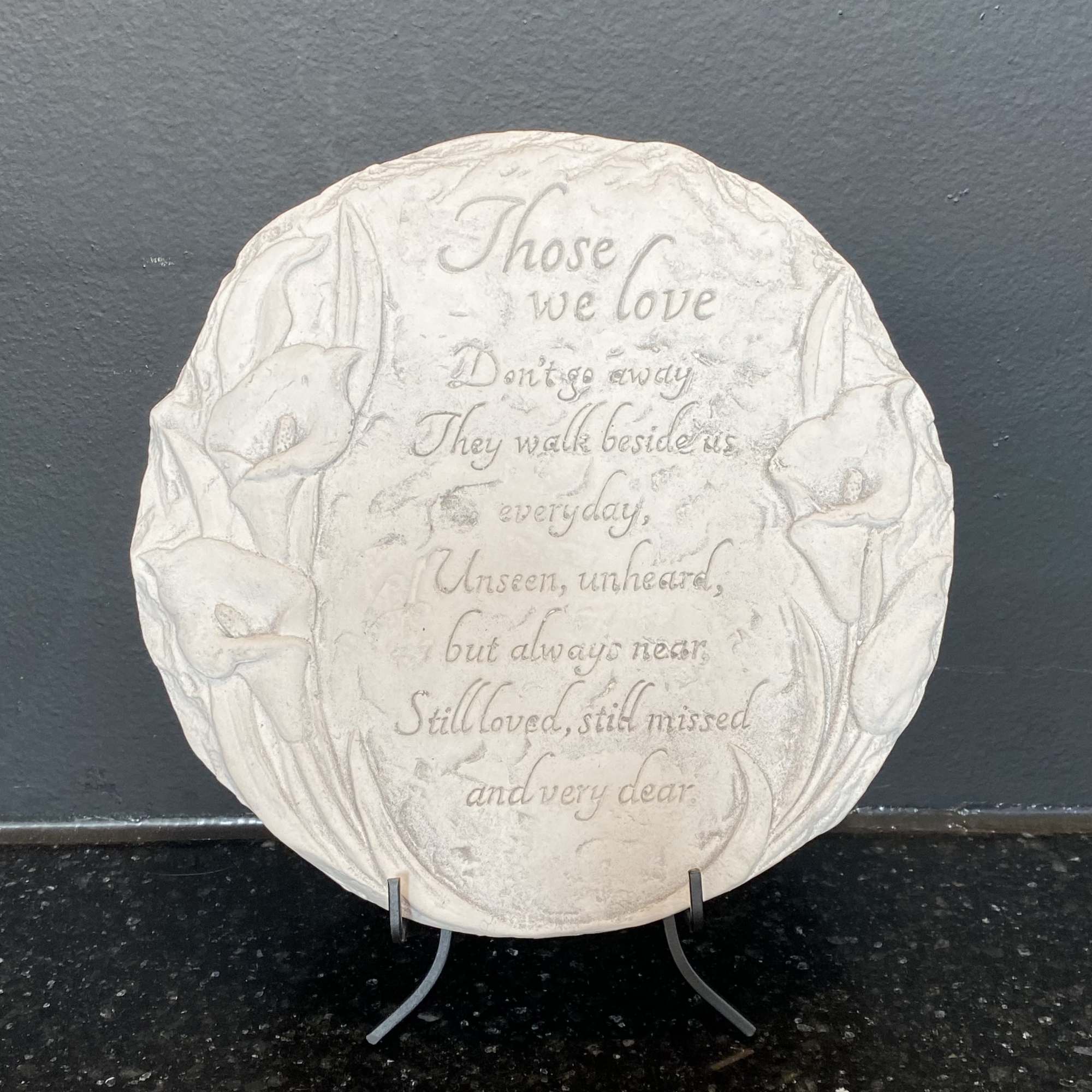 Round memorial plaque with calla lily relief and engraved verse