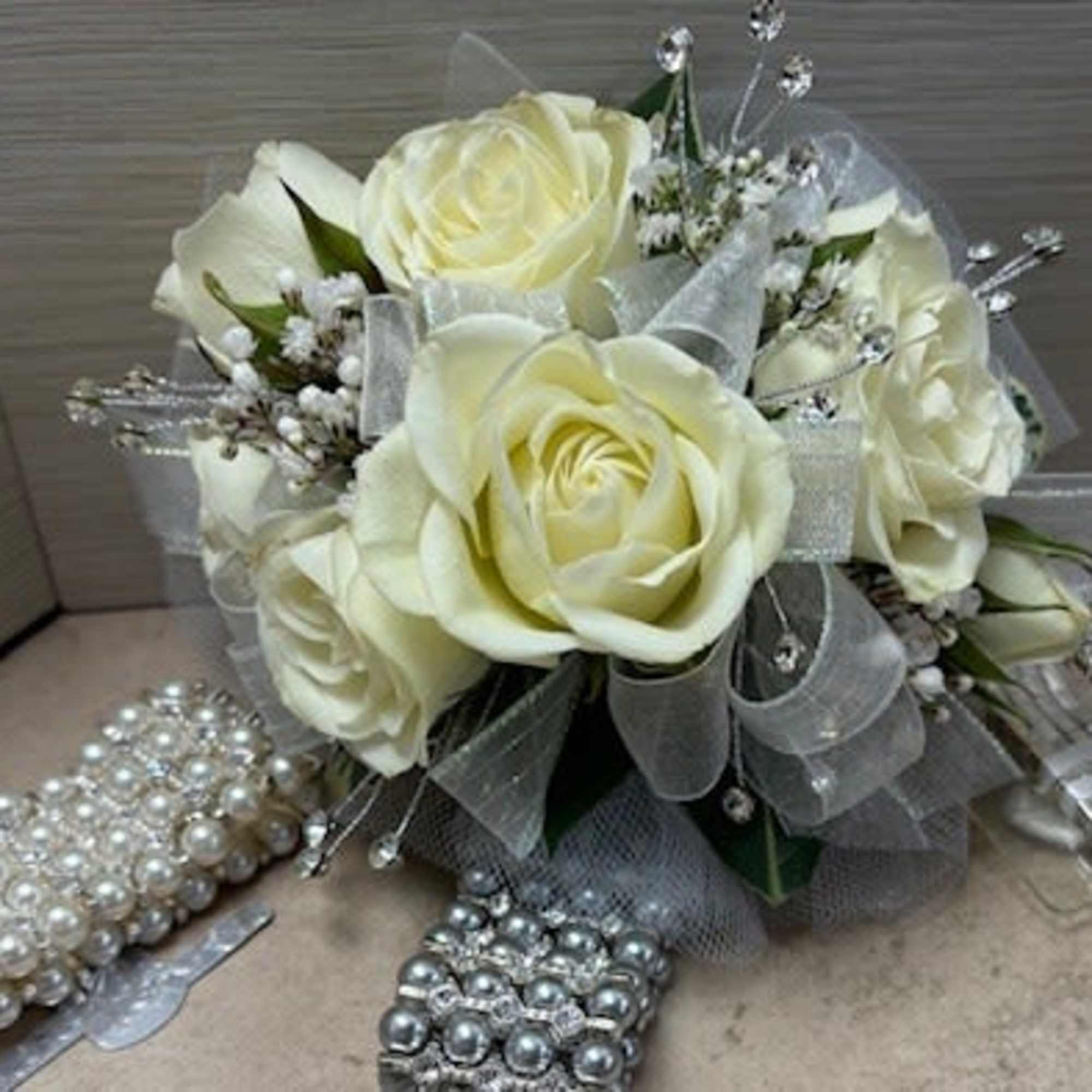Cream rose bouquet with silver ribbon and jeweled accents