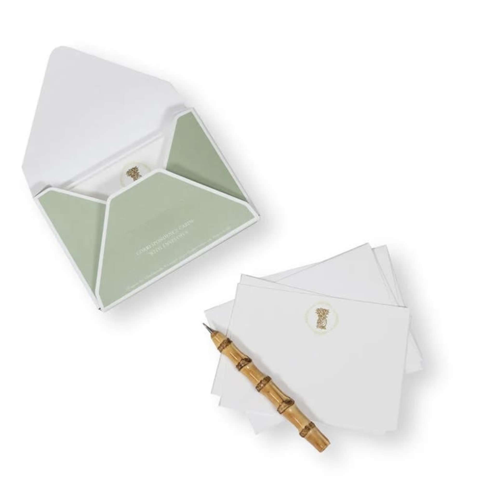 Open stationery box with folded cards and a bamboo pen