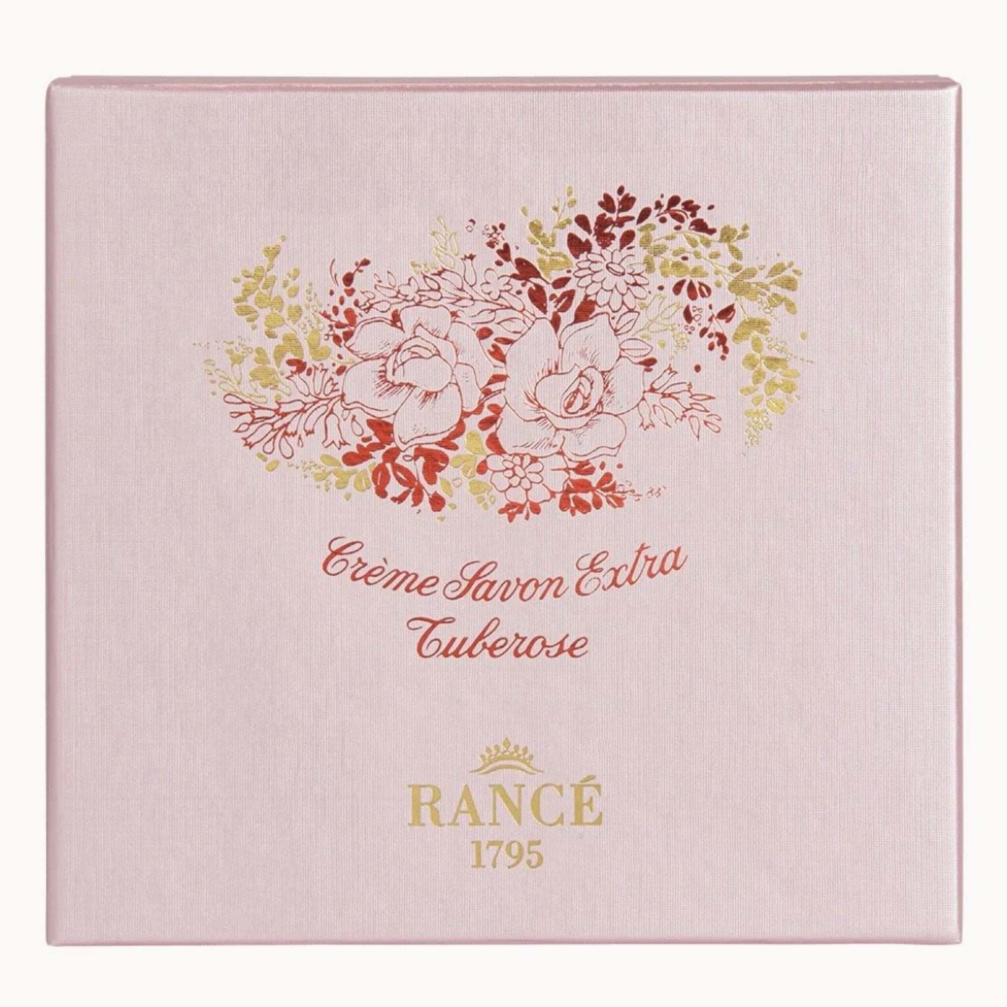 Pink perfume box with floral illustration and gold lettering