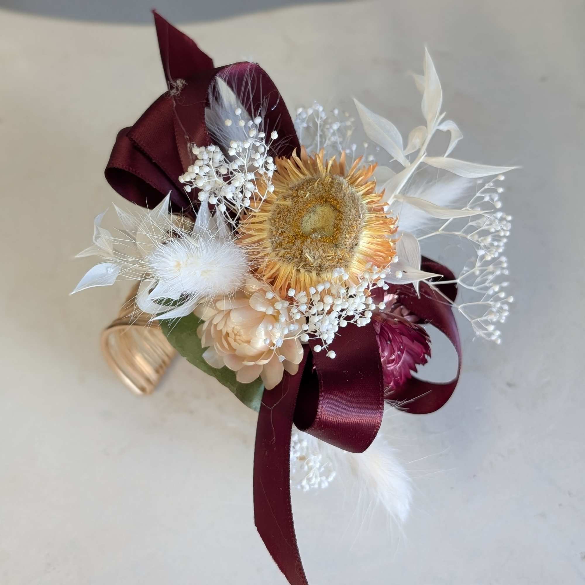 Bleach baby's breath and ruscus dressed up with bunny tails and peach