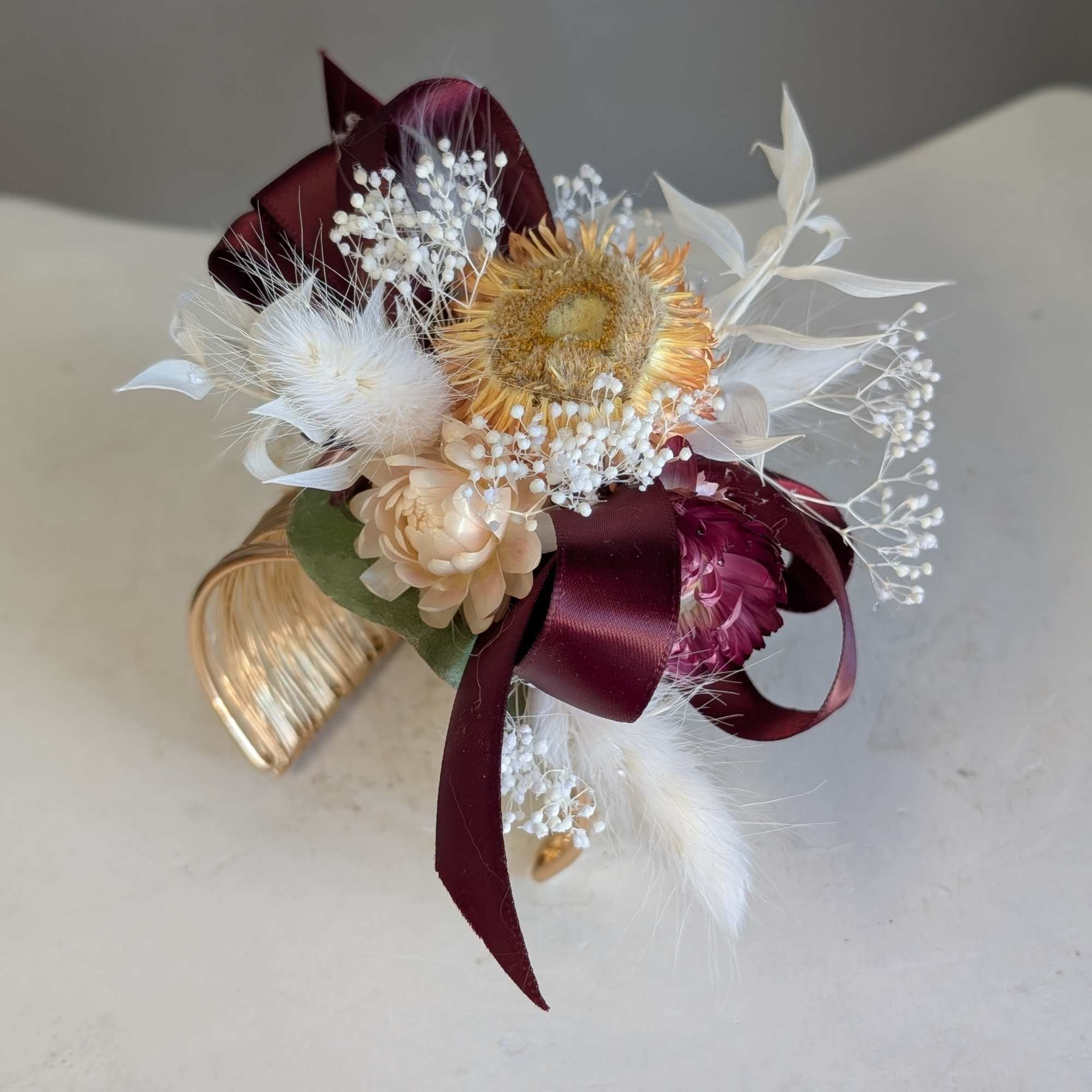 Bleach baby's breath and ruscus dressed up with bunny tails and peach
