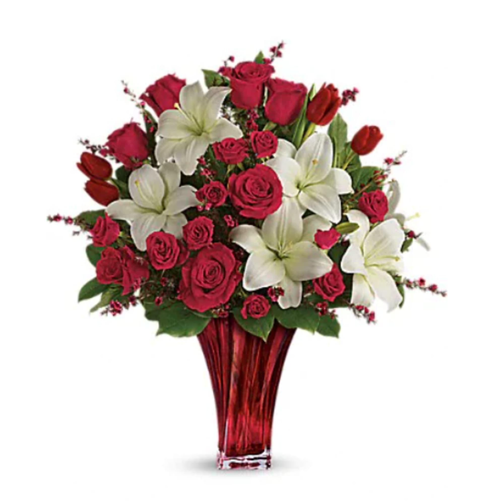 Bouquet of red roses and white lilies in a red glass vase