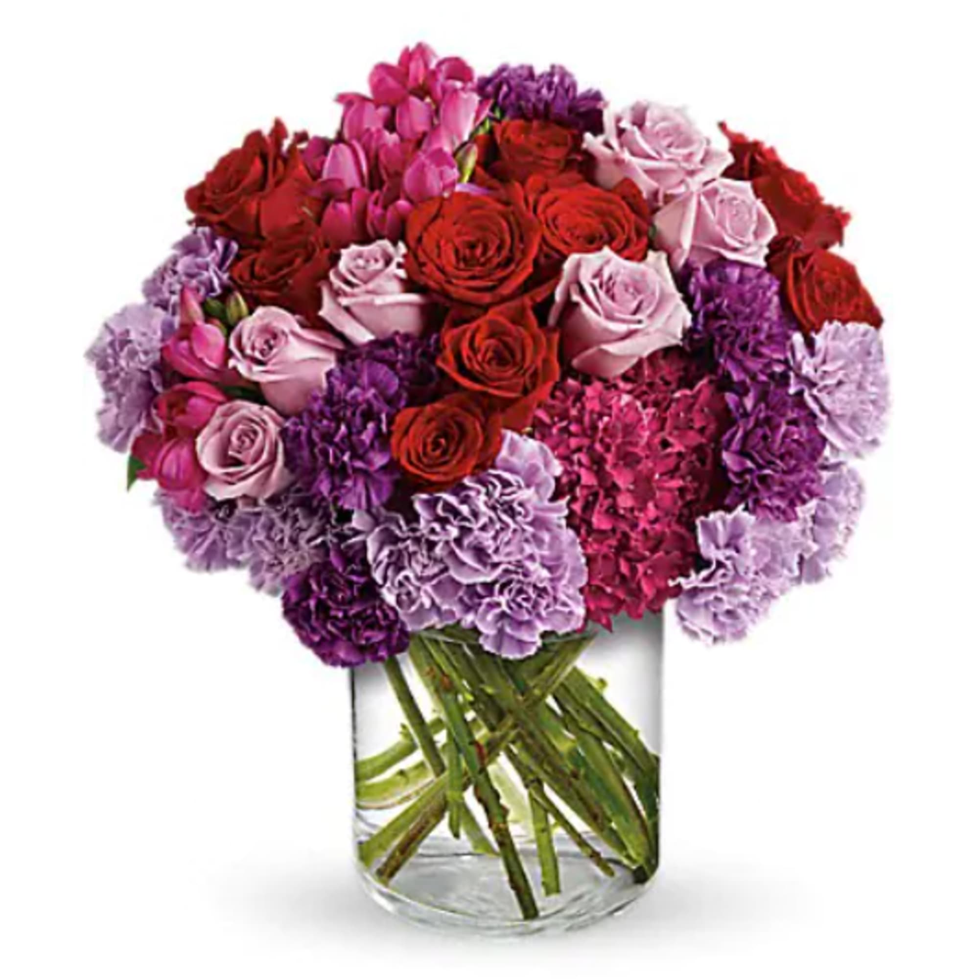 Bouquet of red, pink, and purple flowers in a clear glass vase