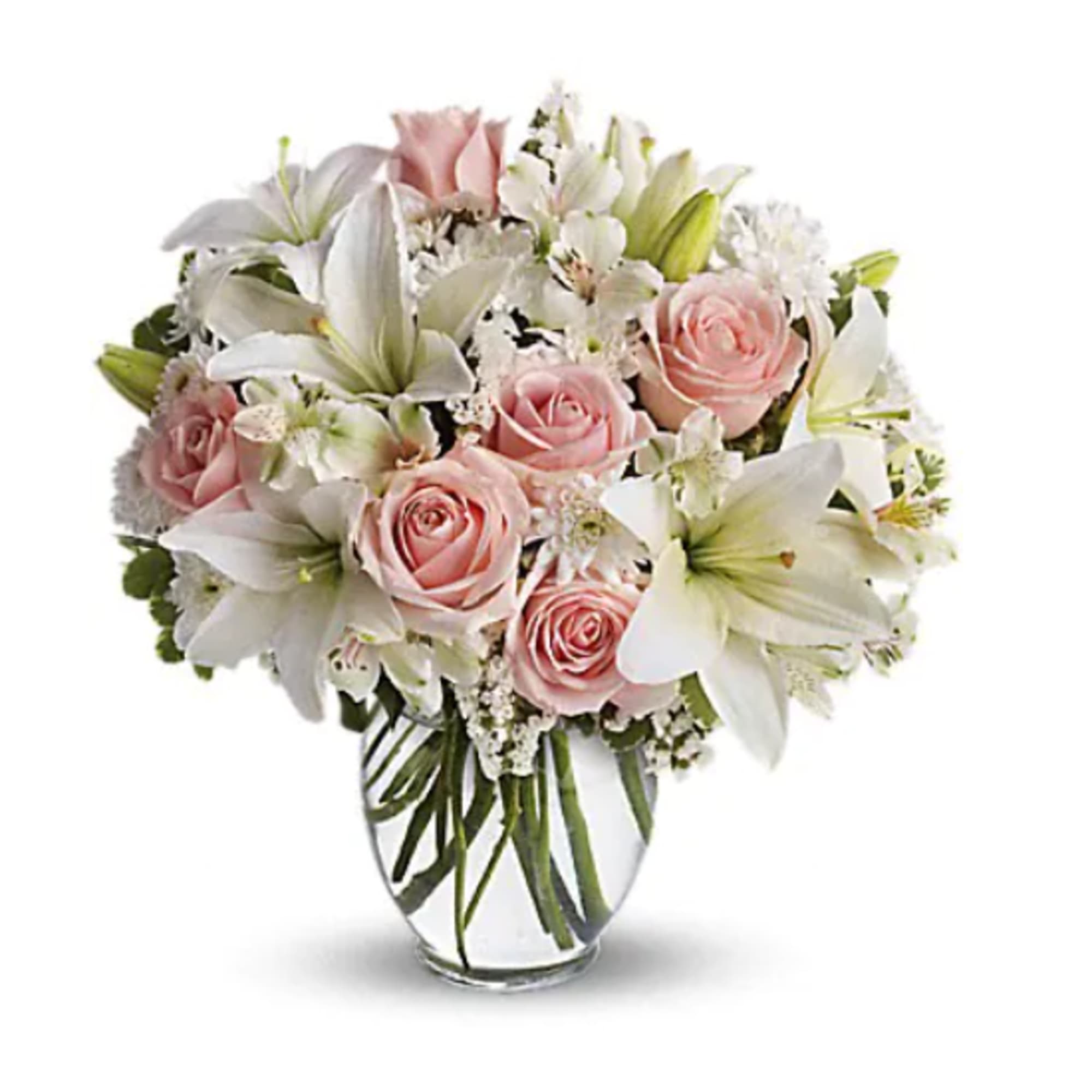 Pink roses and white lilies arranged in a clear glass vase