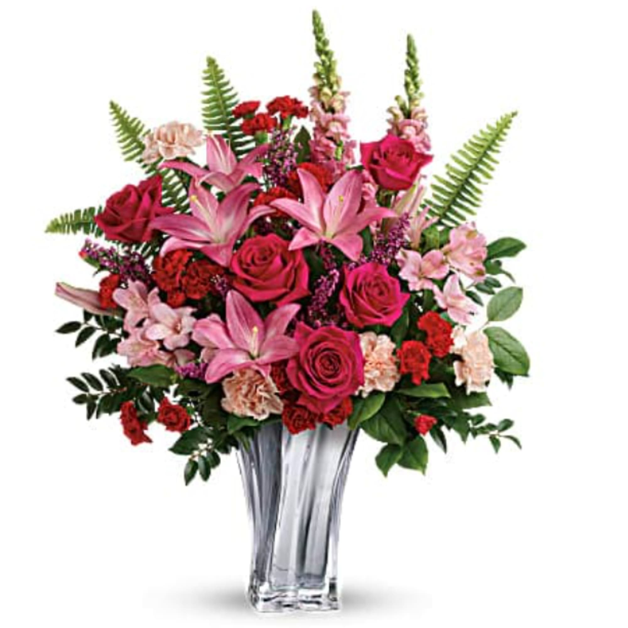 Pink lilies and roses arranged in a clear glass vase
