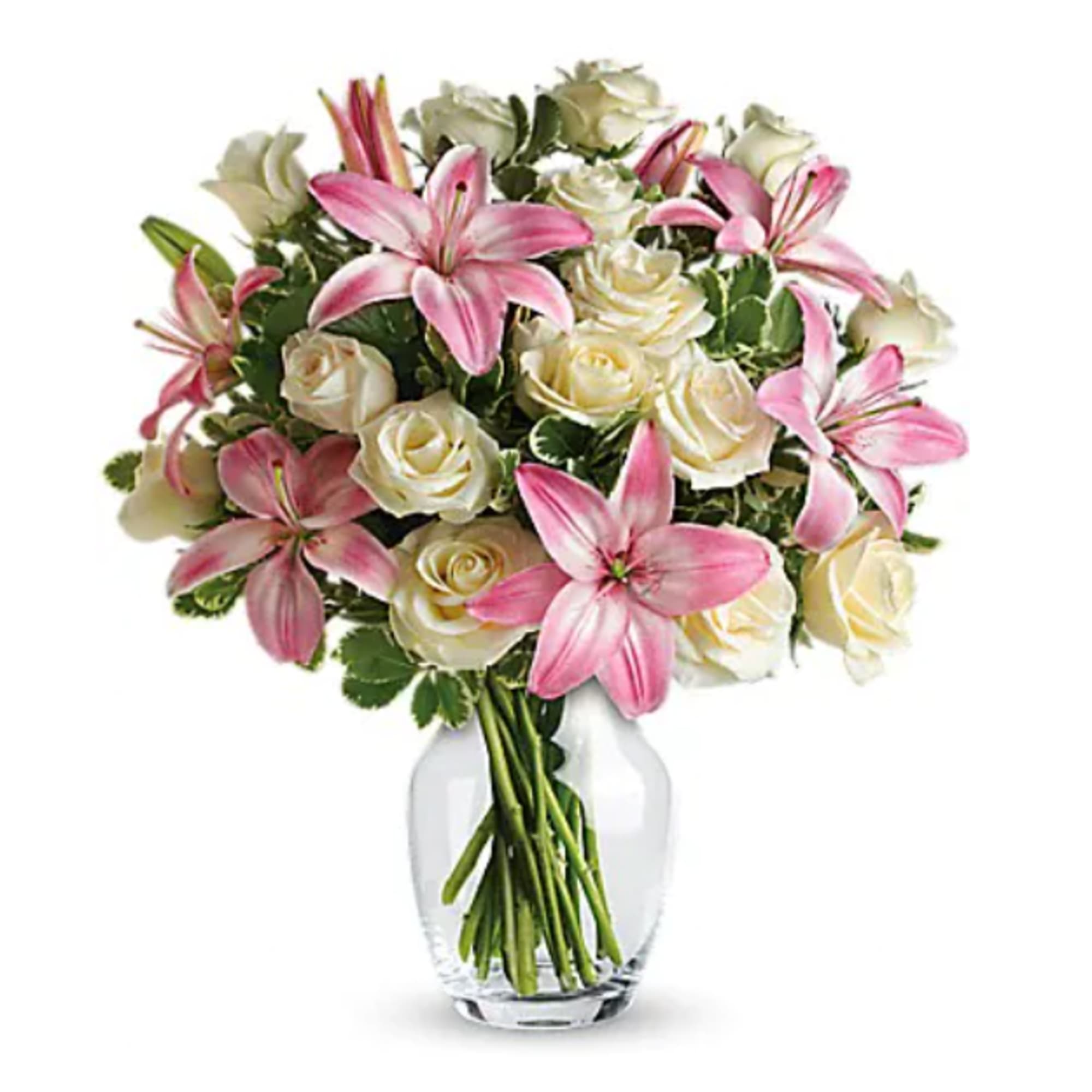 Pink lilies and white roses in a clear glass vase