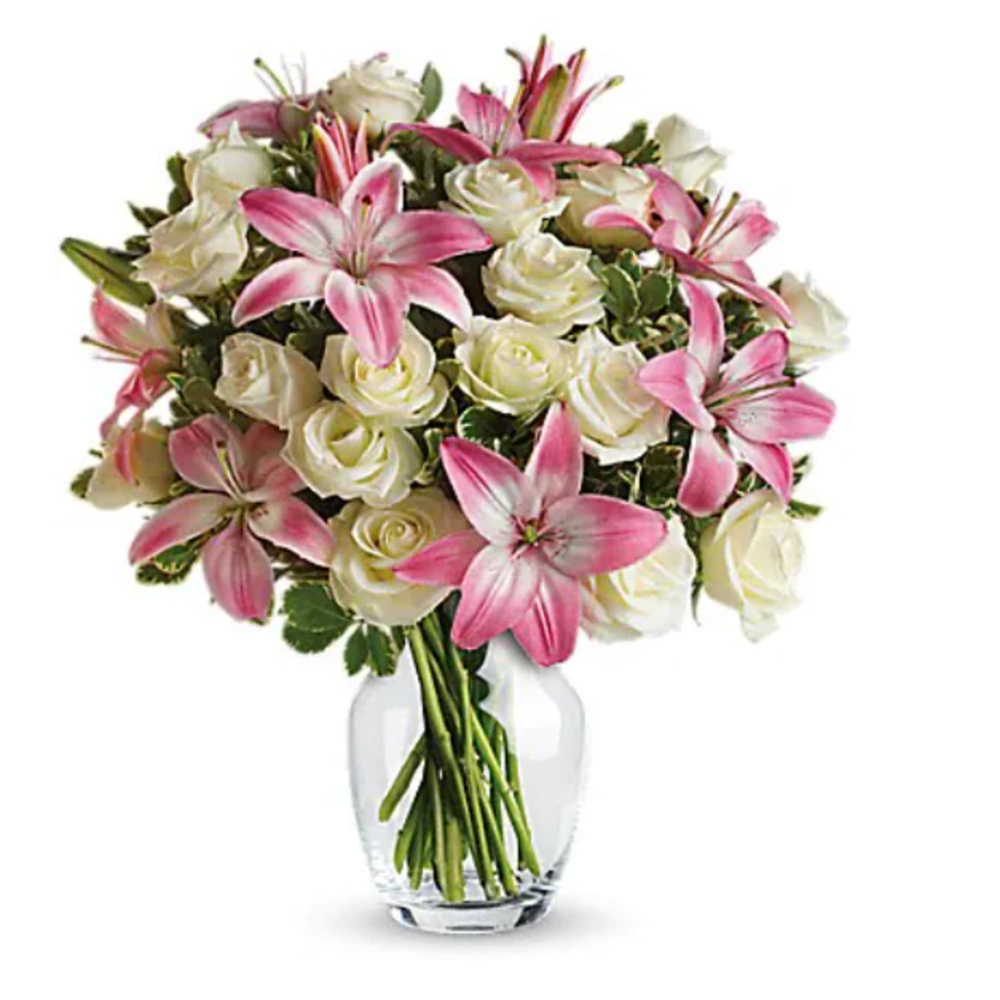 Pink lilies and white roses in a clear glass vase