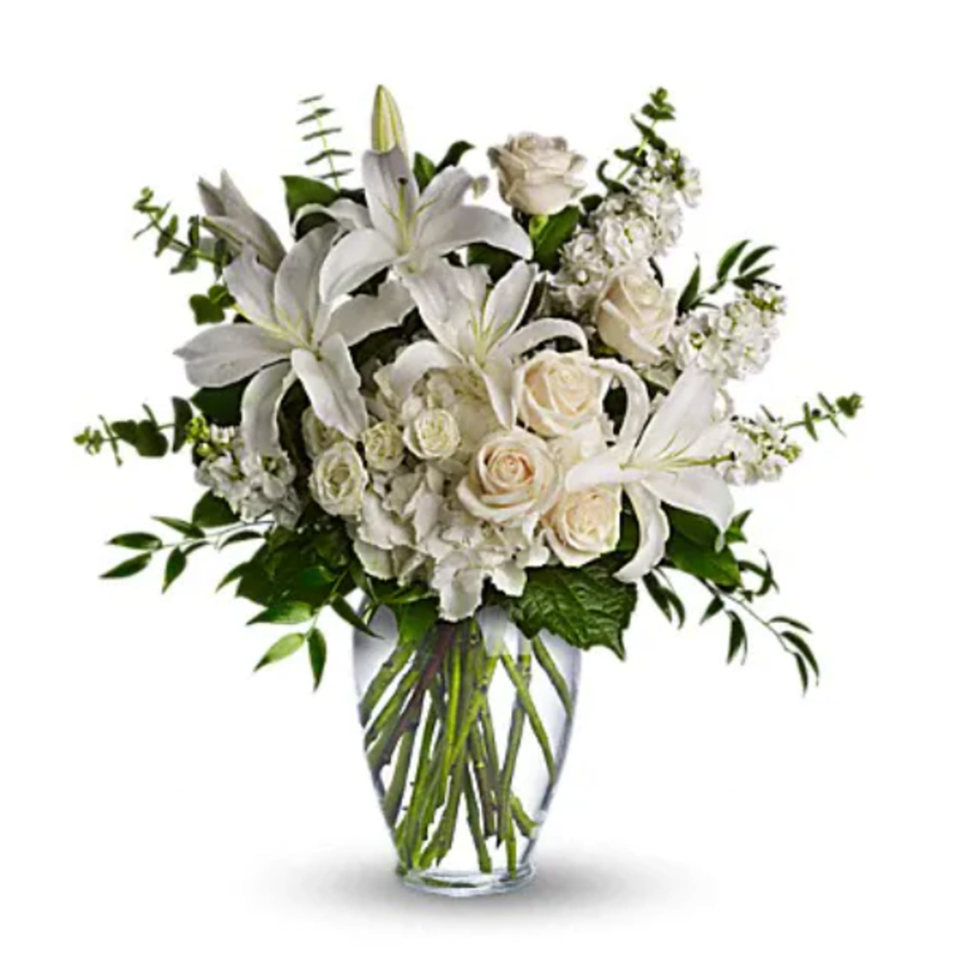 White lilies and roses arranged in a clear glass vase