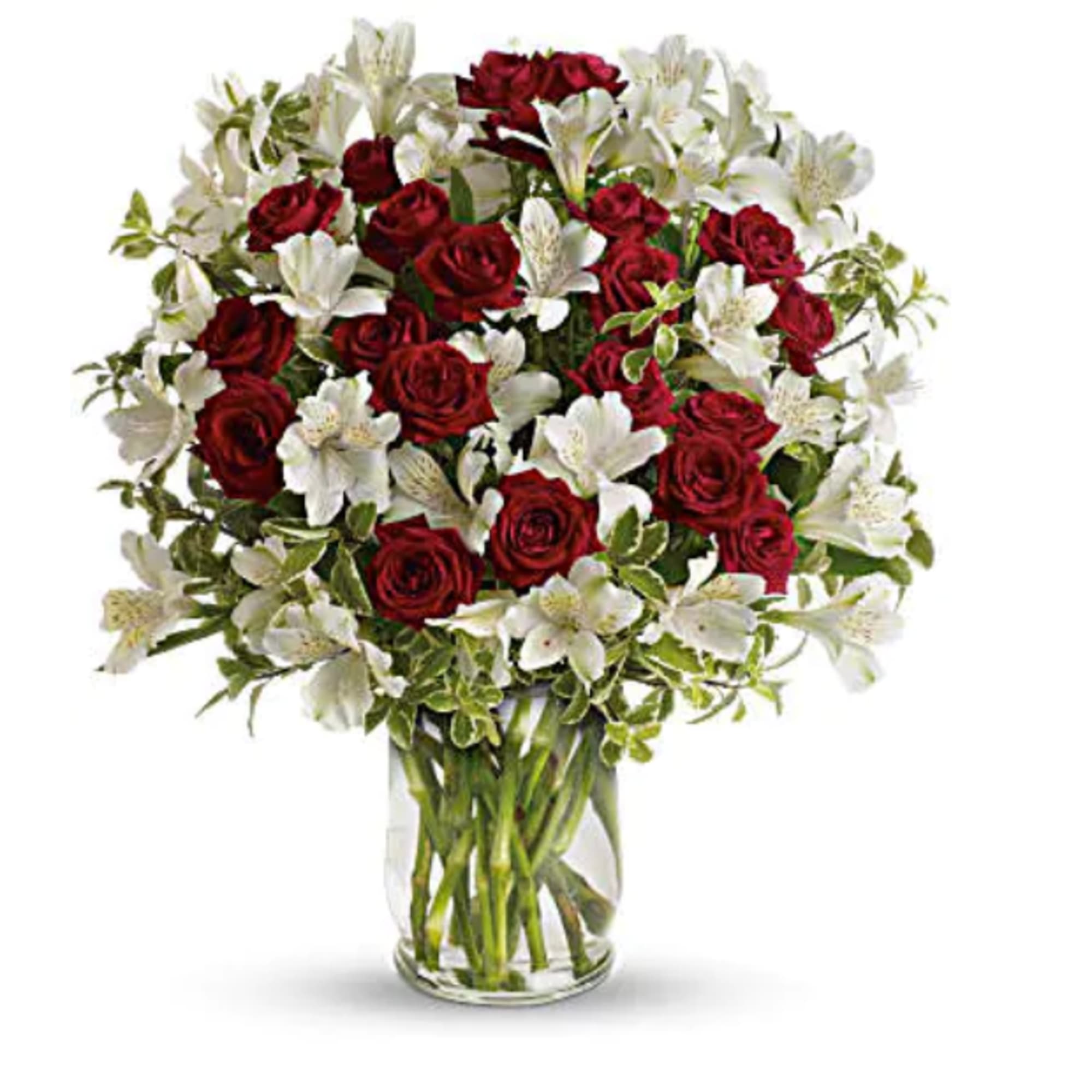 Red roses and white lilies in a clear glass vase