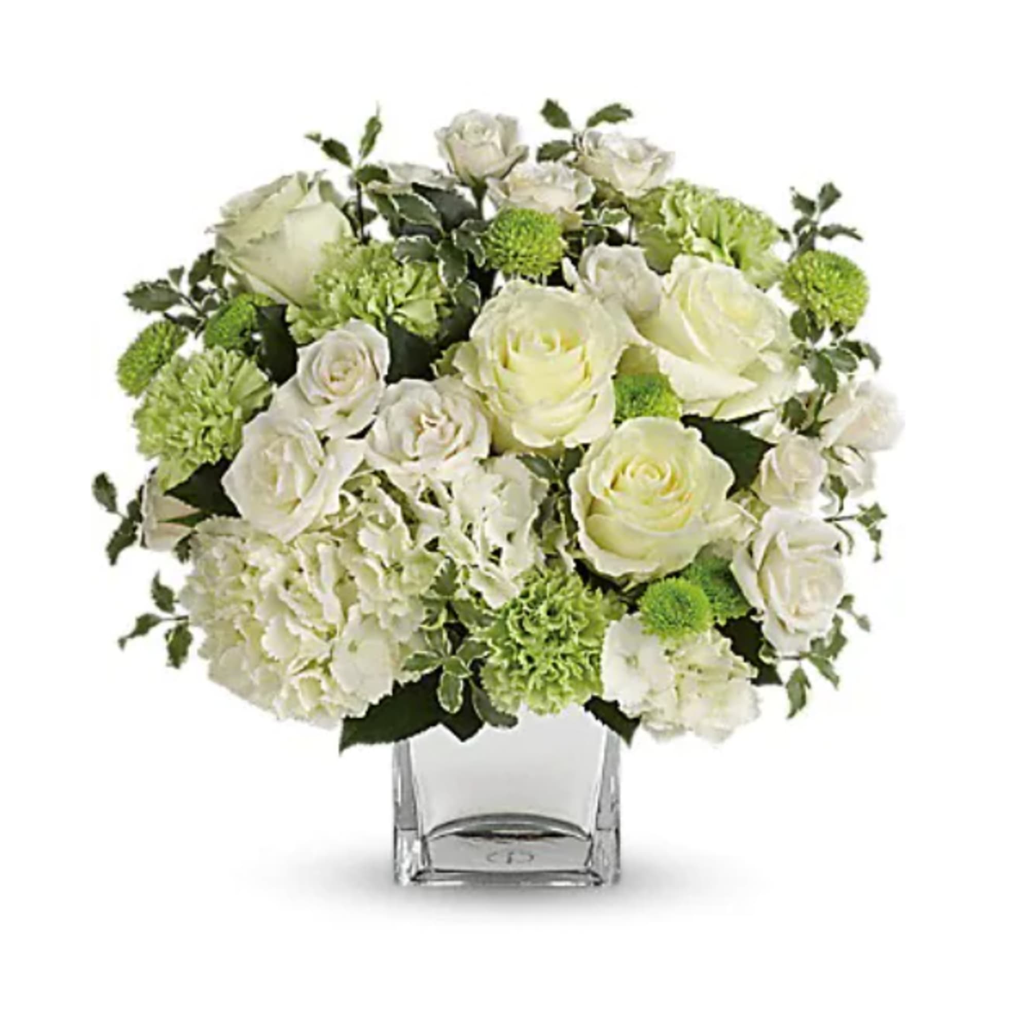 White roses and green blooms arranged in a clear square vase