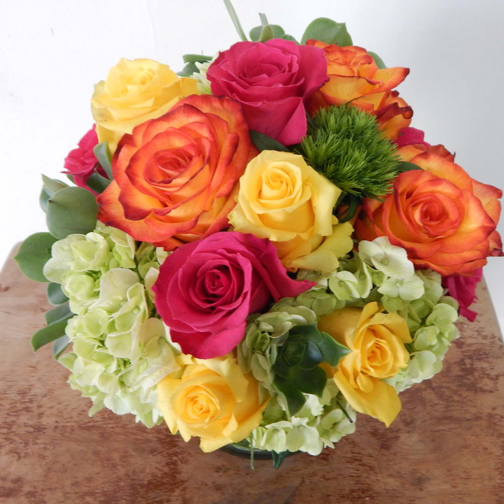 Bouquet of multicolored roses with pale hydrangeas