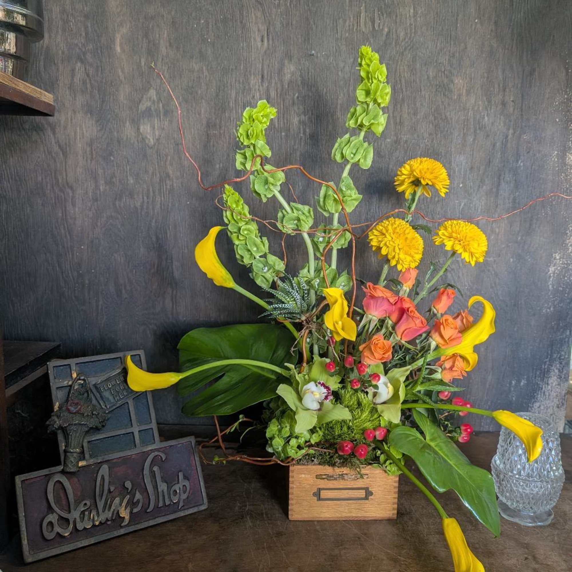 Callas, spray roses bell of Ireland and more. Boxes are vintage and