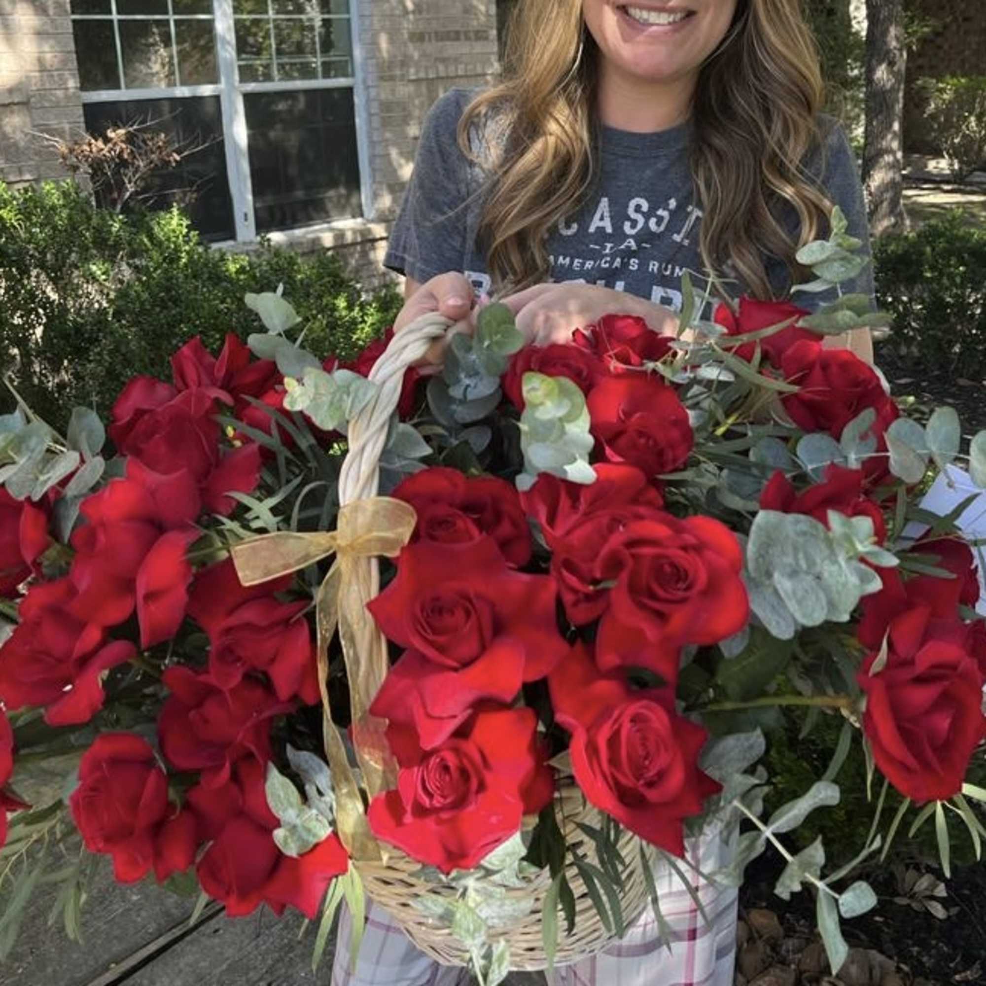 Large basket of red roses with eucalyptus greenery