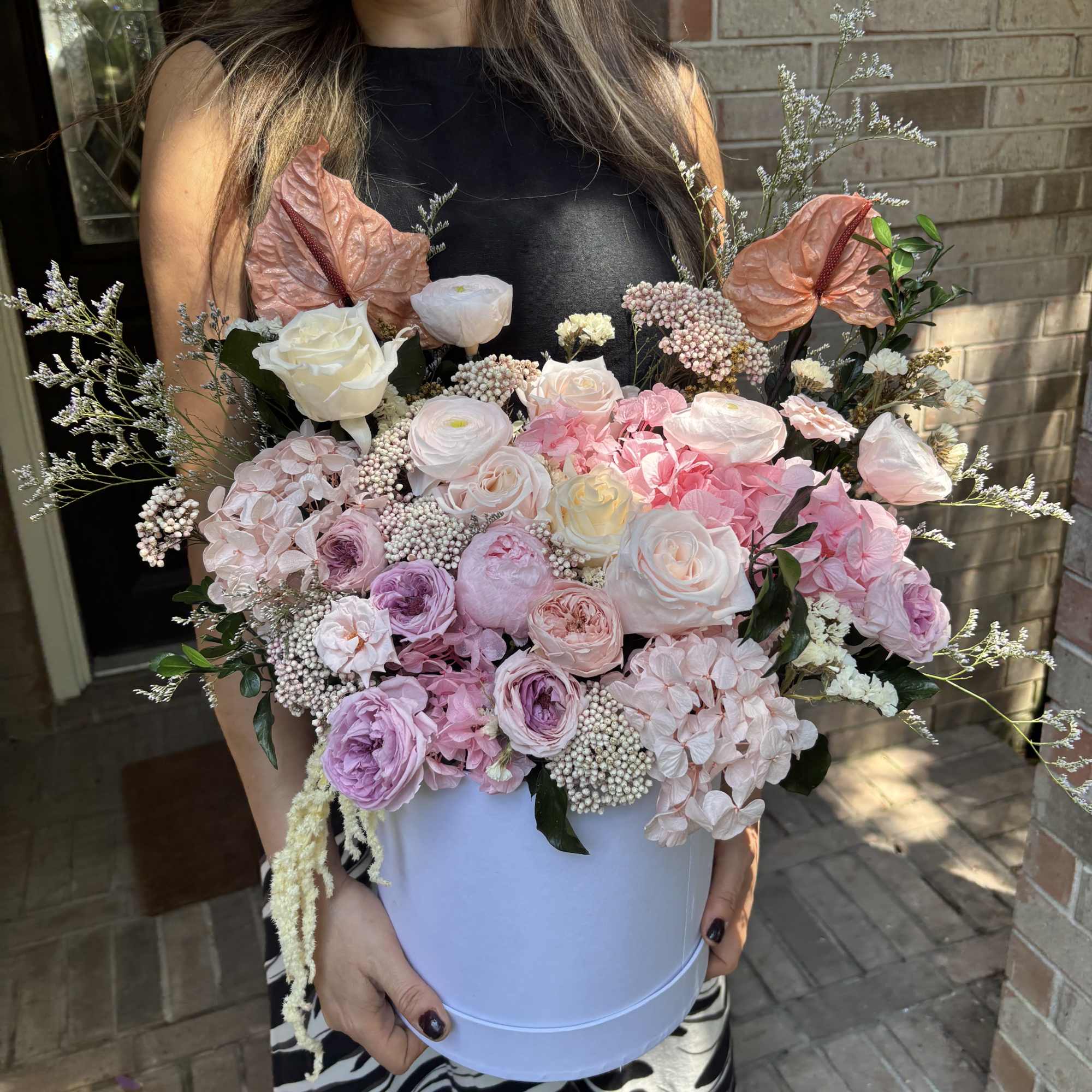 Overflowing with real and natural preserved roses, hydrangeas, ranunculus, carnations and airy