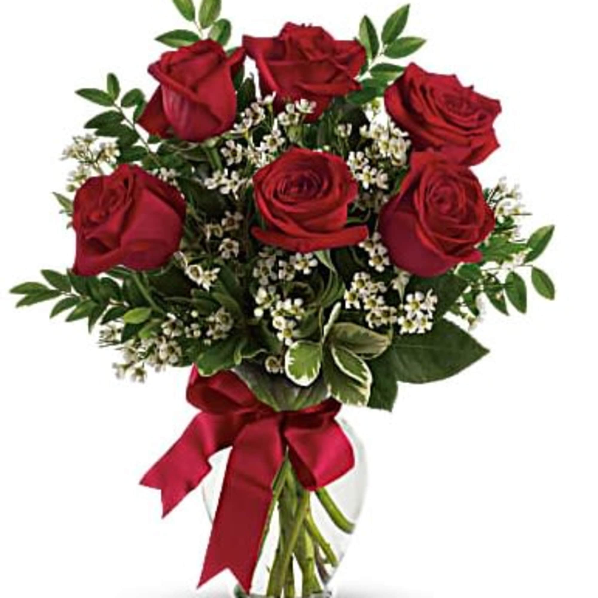 Bouquet of red roses with baby's breath in a glass vase