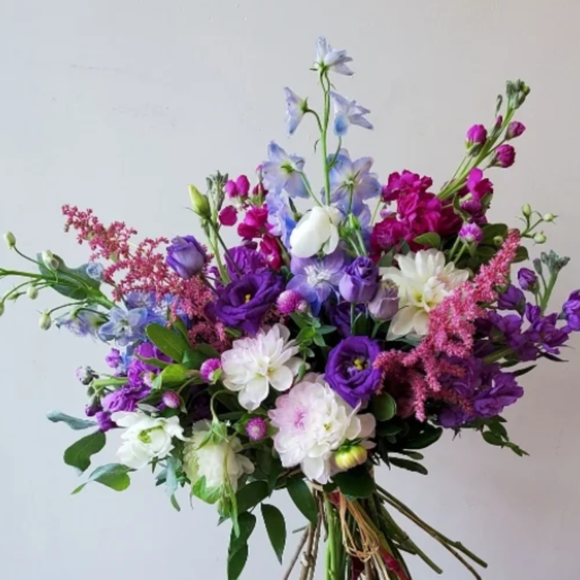 Bouquet of purple, pink, and white flowers with mixed blooms