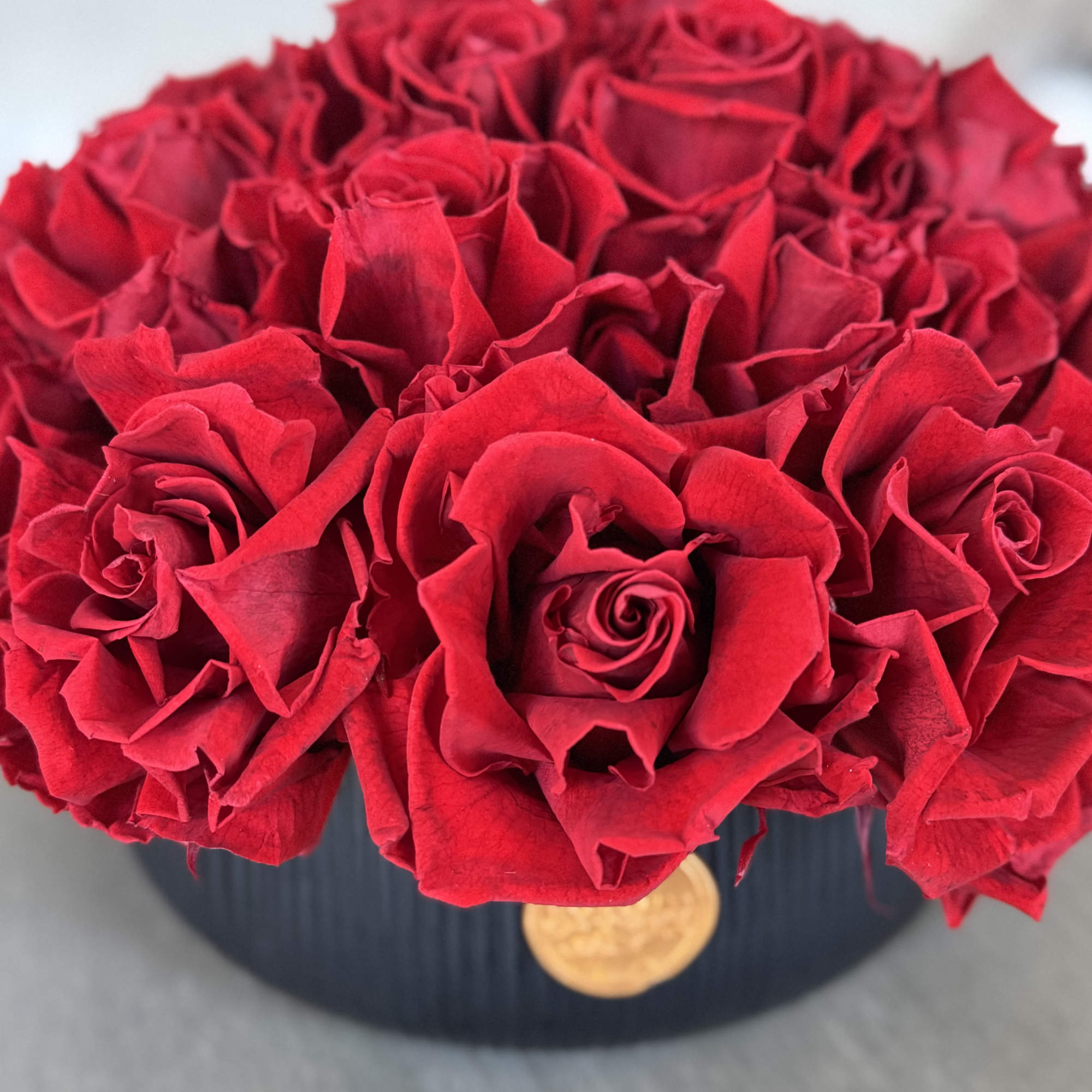 Bouquet of red roses in a black round box