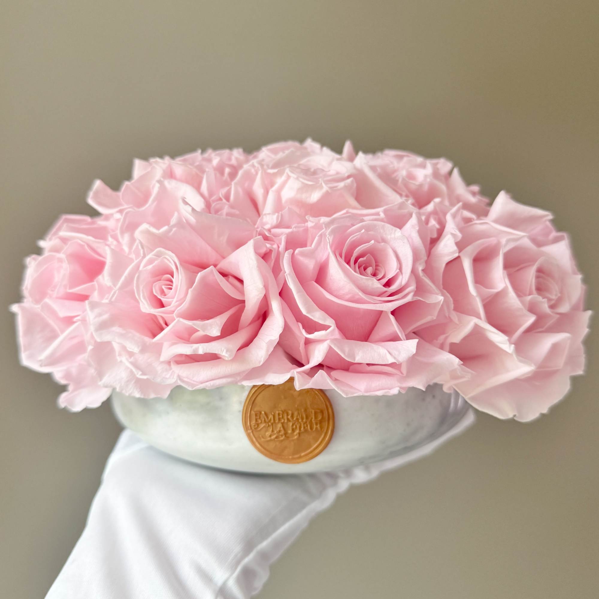 Pink rose bouquet in a round hat box with a ribbon