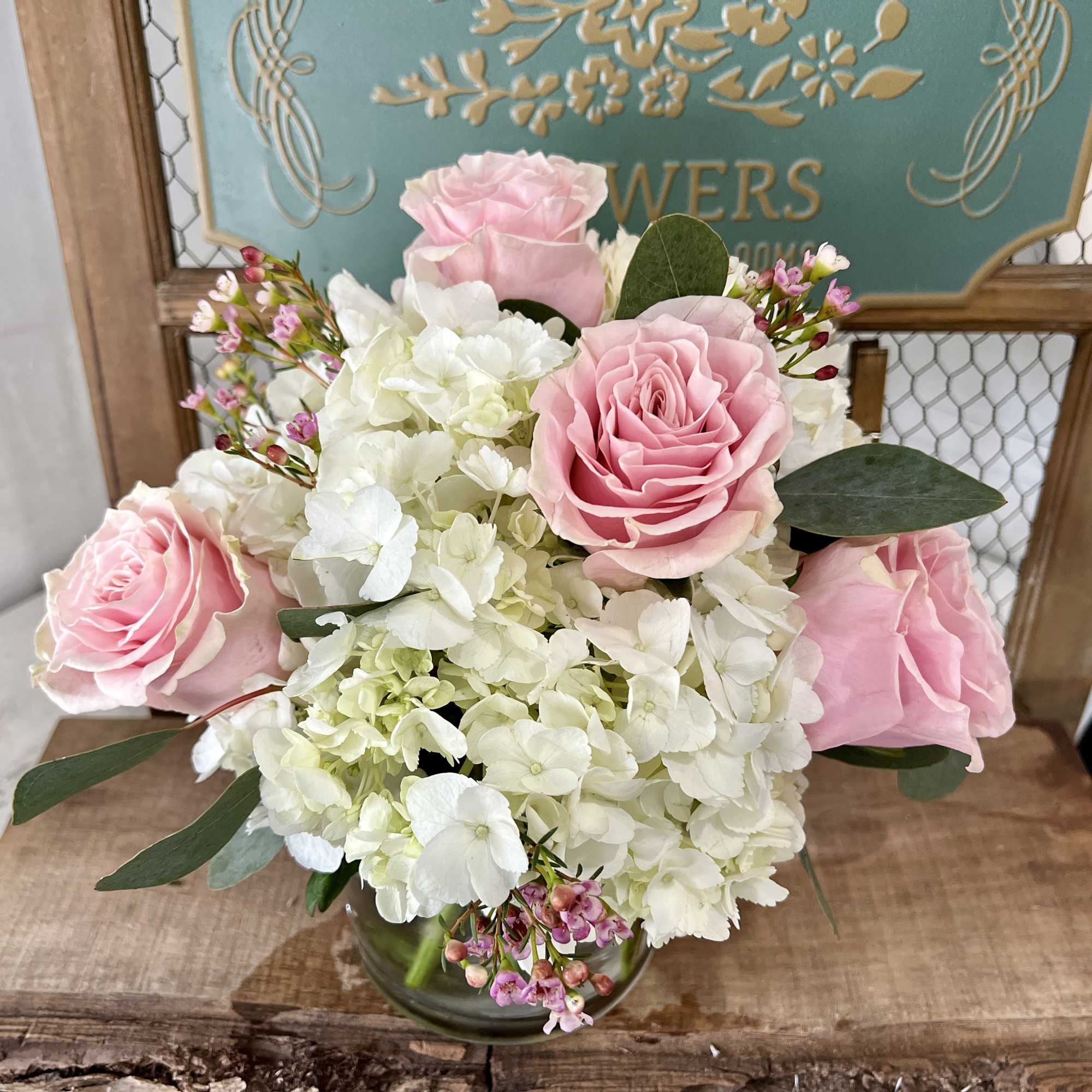 Pink roses and white hydrangeas in a glass vase
