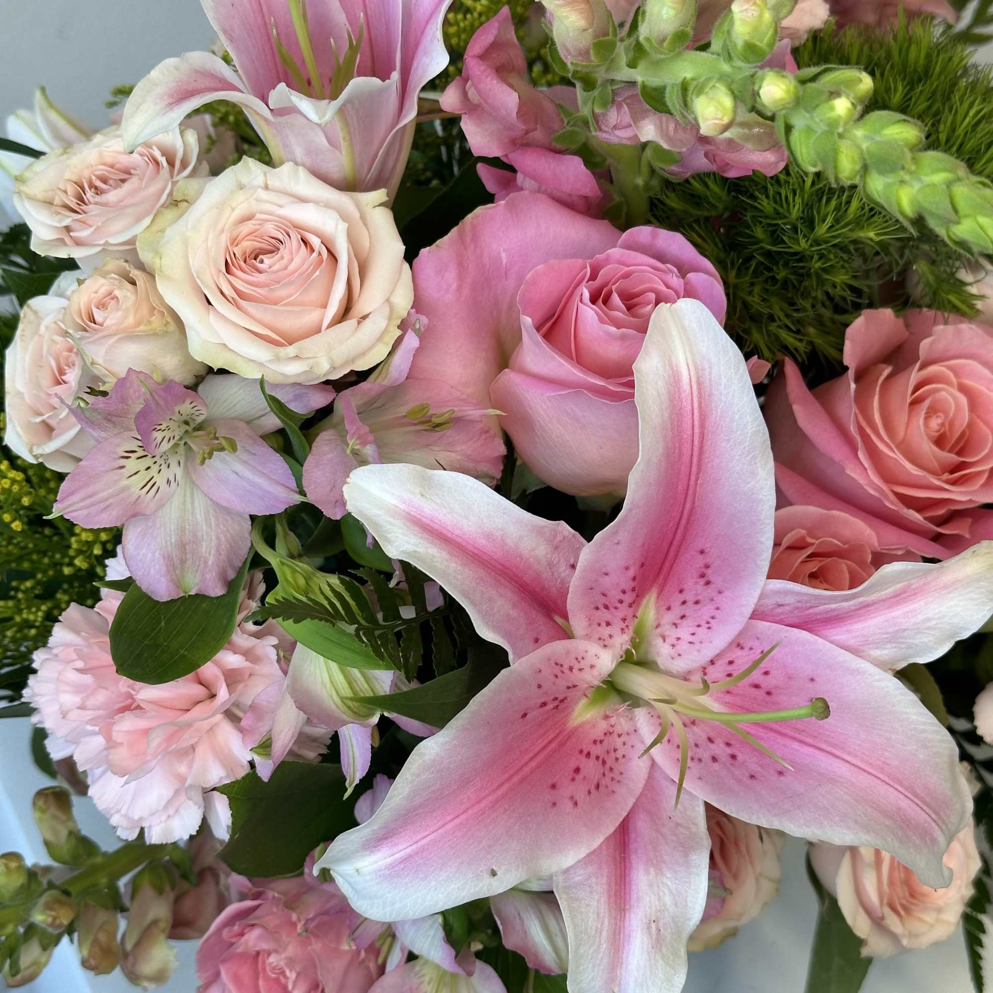 Pink lilies and roses in a mixed bouquet