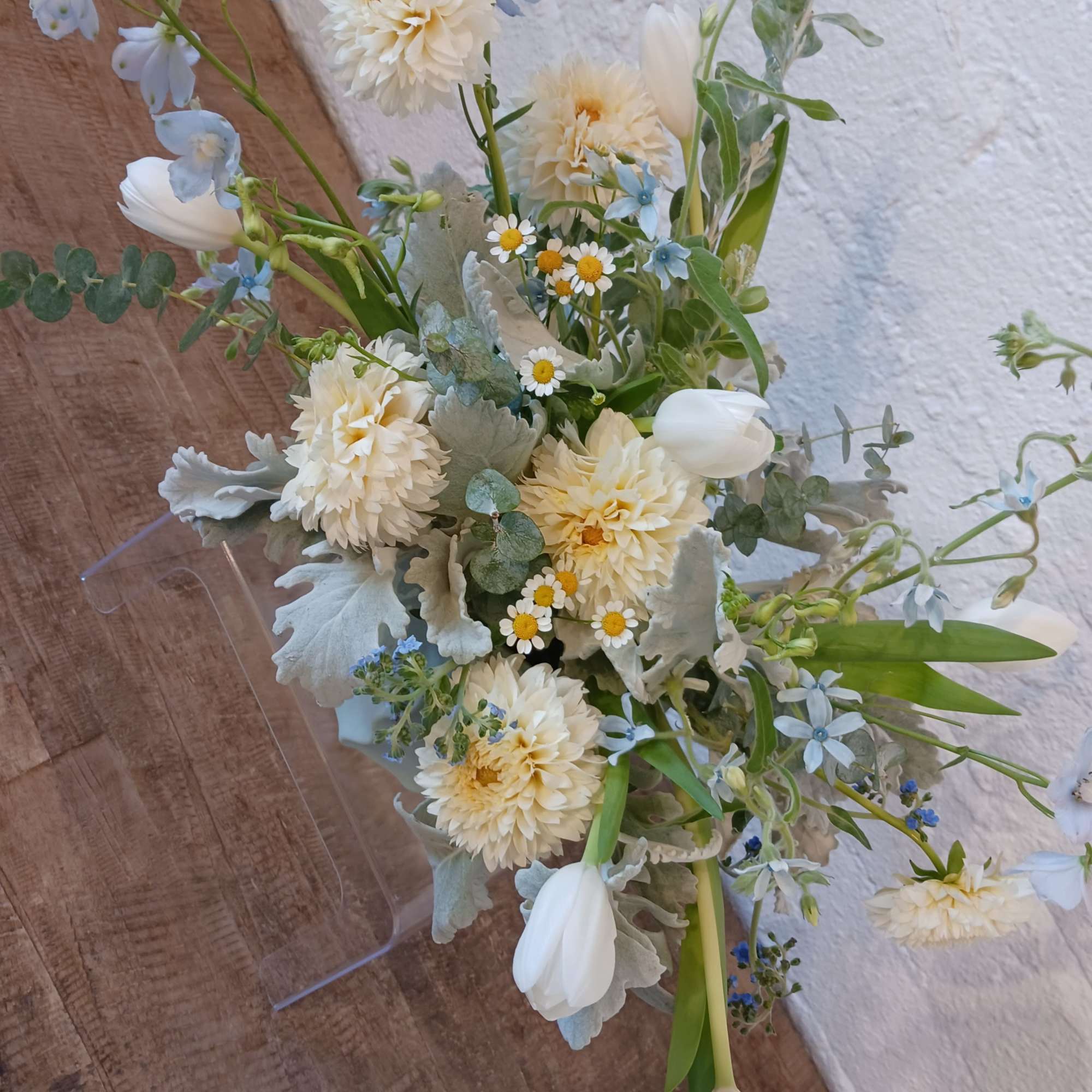 Loose bouquet of white and pale blue flowers with silvery foliage