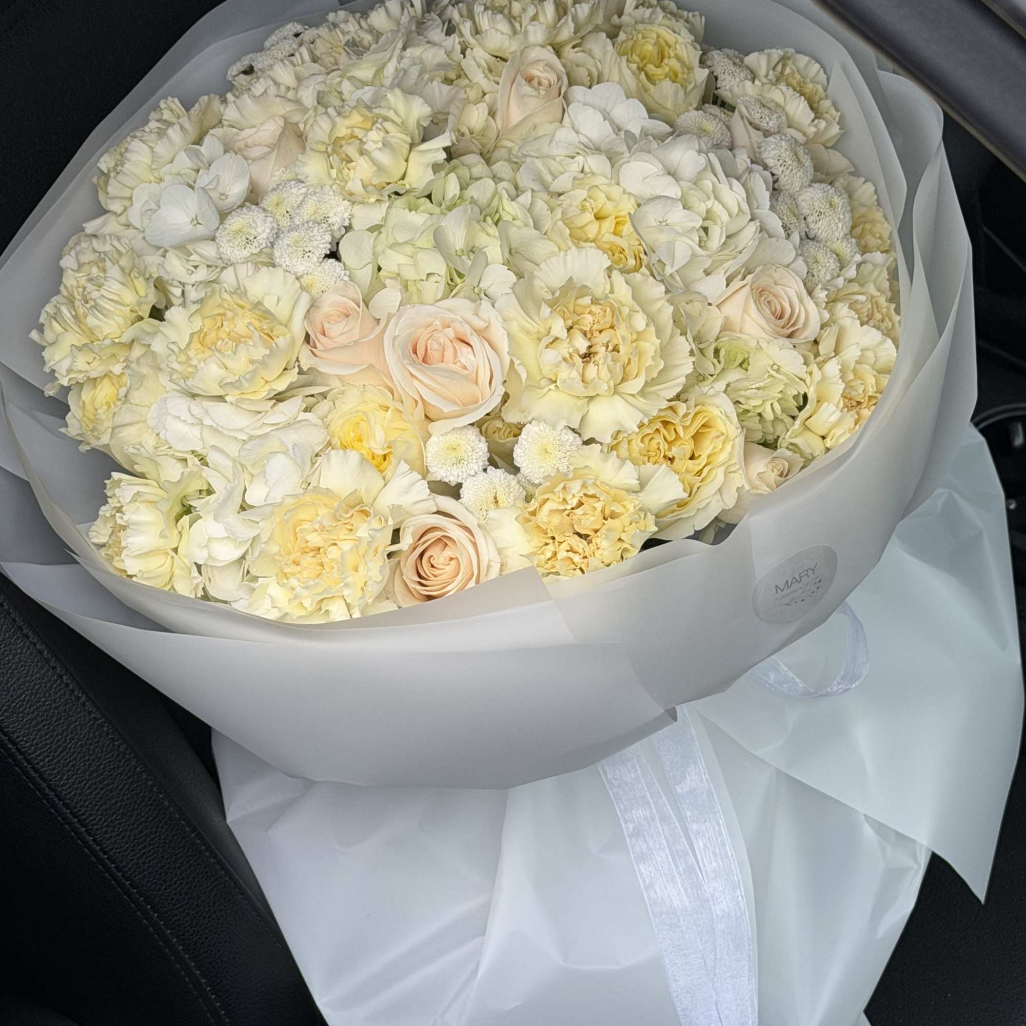 This refined arrangement features a harmonious blend of premium ivory and soft