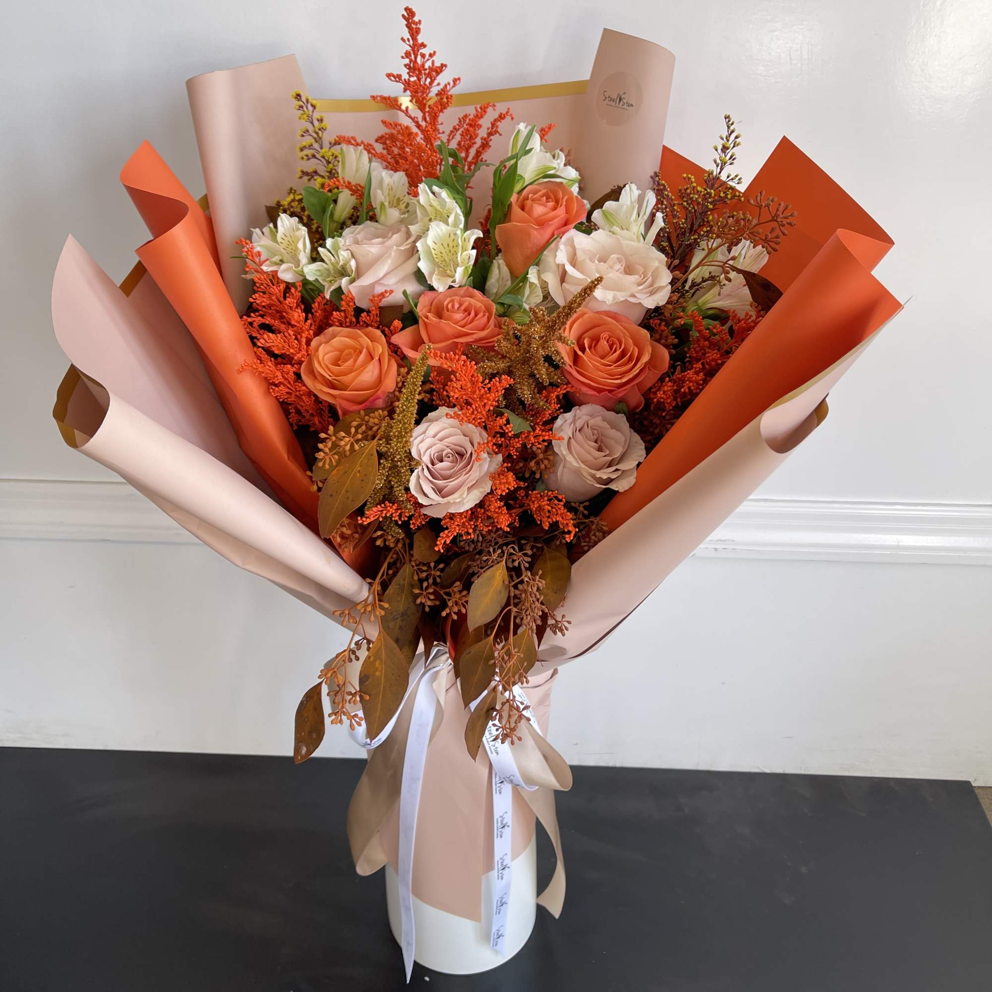 A wonderful mixture of autumn colored flowers that creates the perfect gift