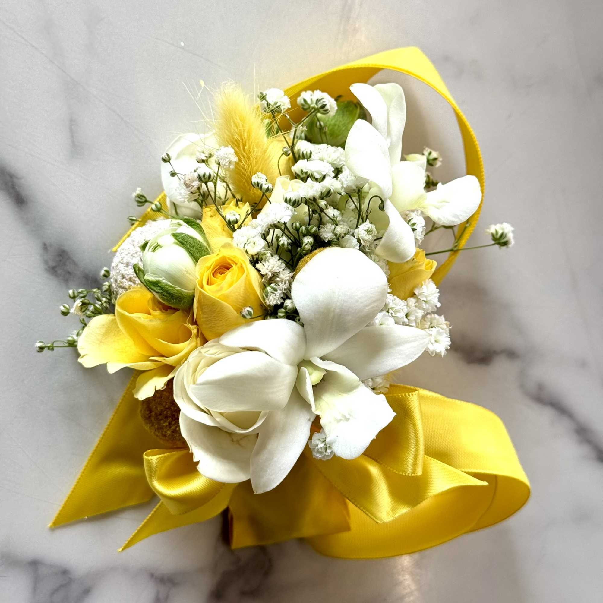 Elevate your look with this stunning corsage and boutonniere, perfect for wedding