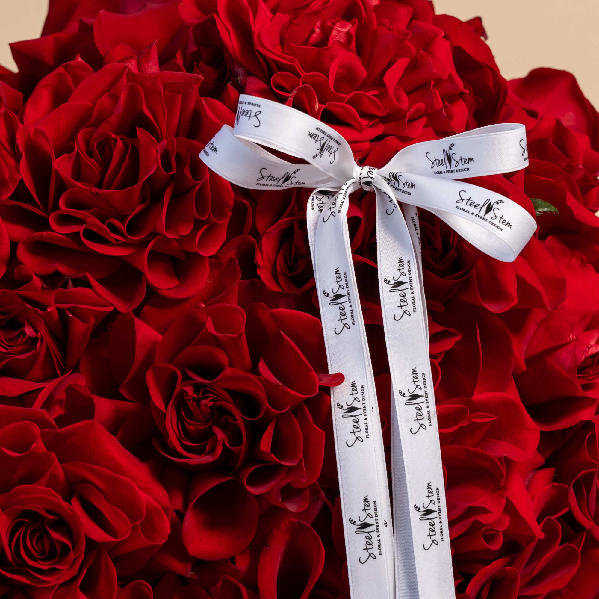 Large bouquet of red roses tied with a white ribbon