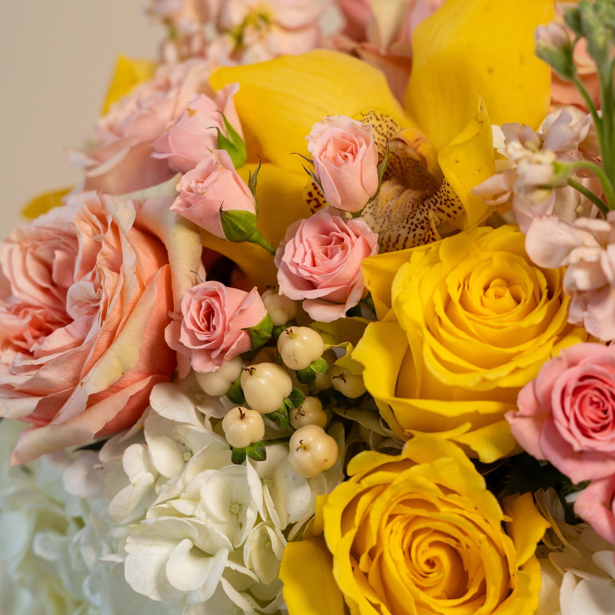 Bouquet of yellow and pink roses with white hydrangeas