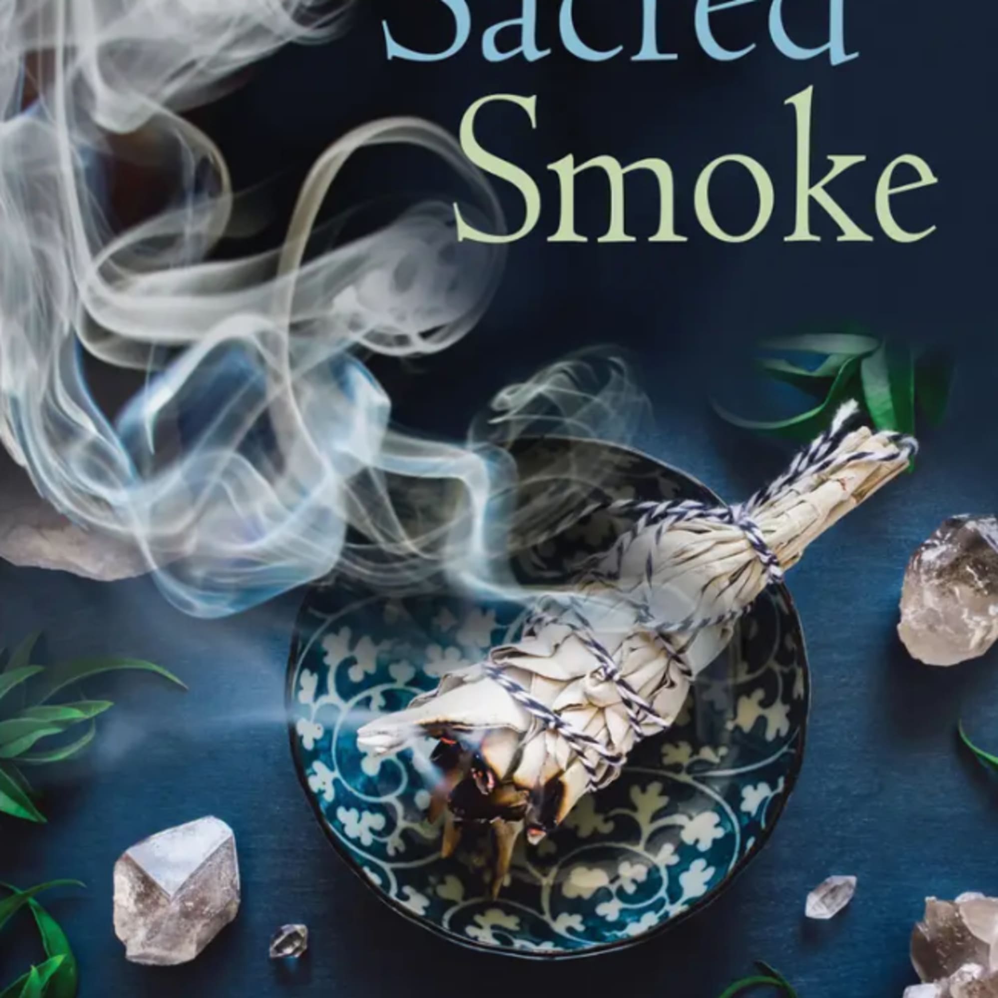 Book cover with smoke, a smoldering sage bundle, and crystals