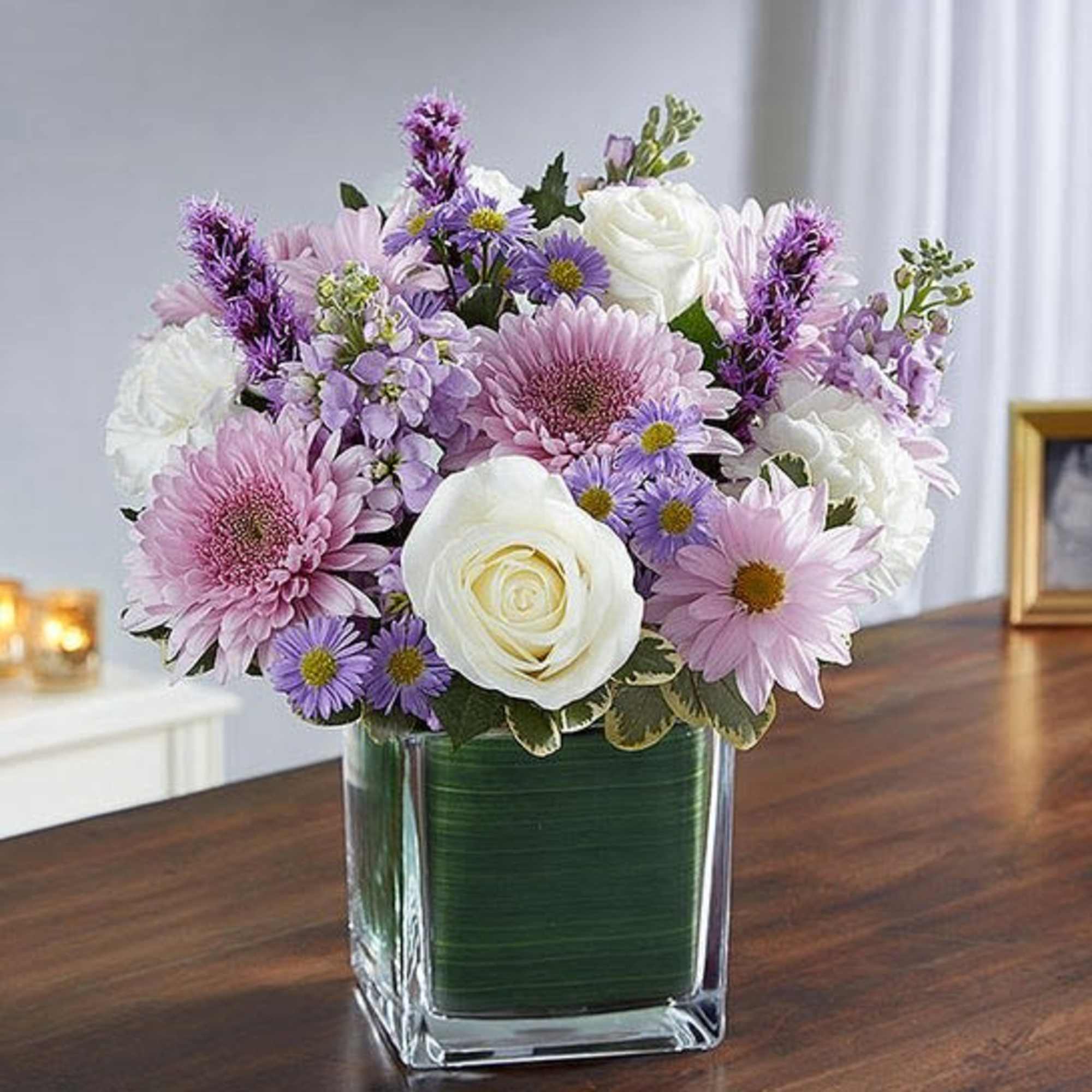 Lavender and white bouquet in a square glass vase