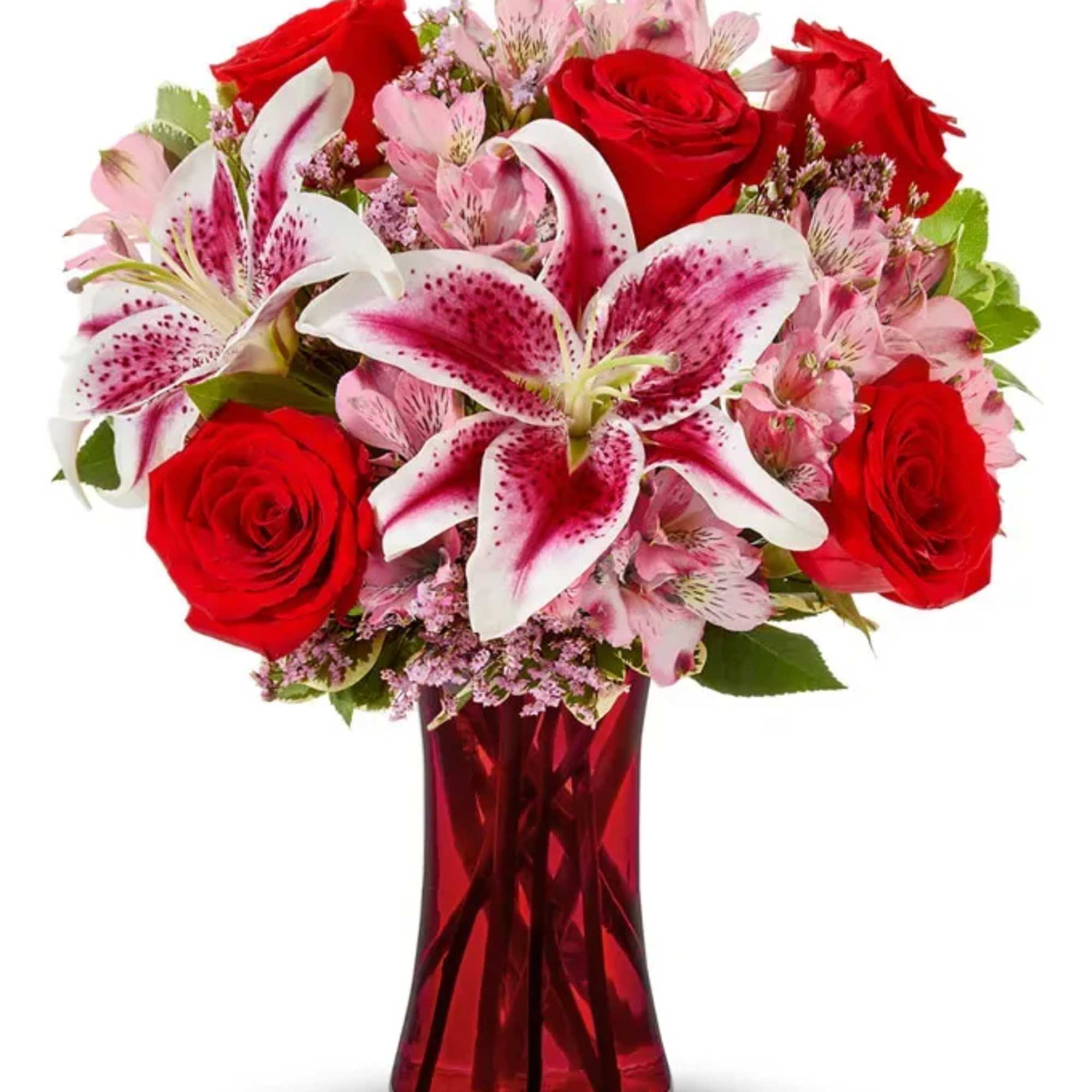 Red roses and pink lilies in a red glass vase