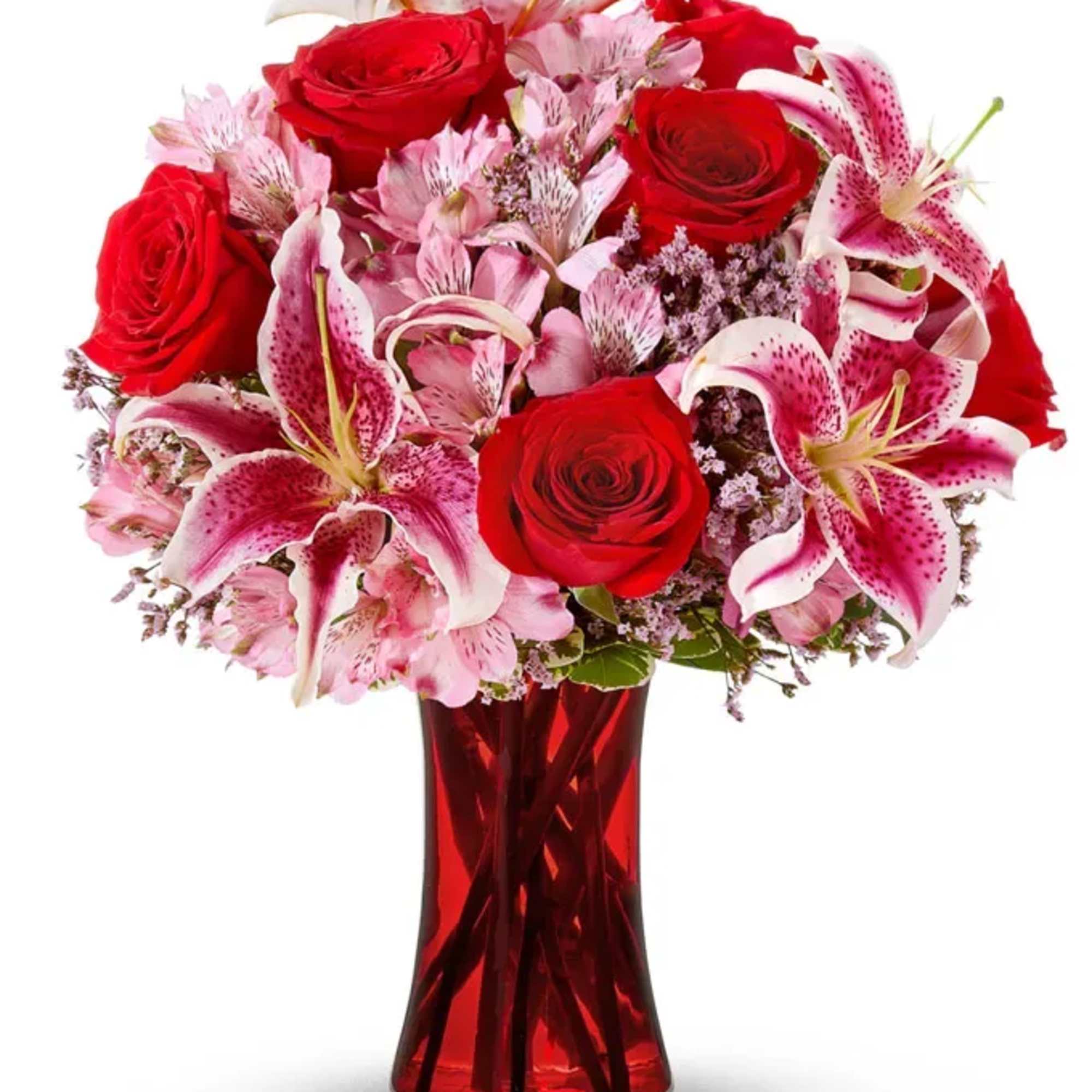 Red roses and pink lilies in a red glass vase