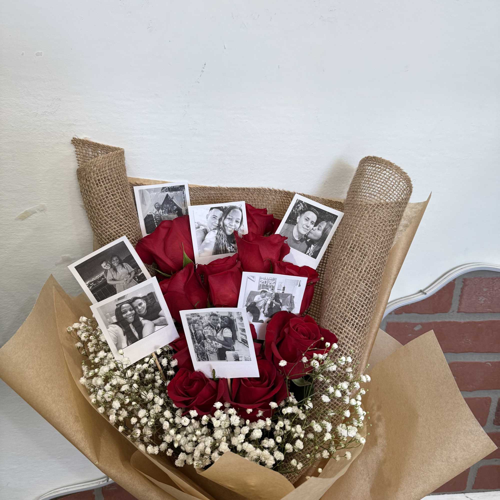 Bouquet of red roses with small photo prints and baby's breath
