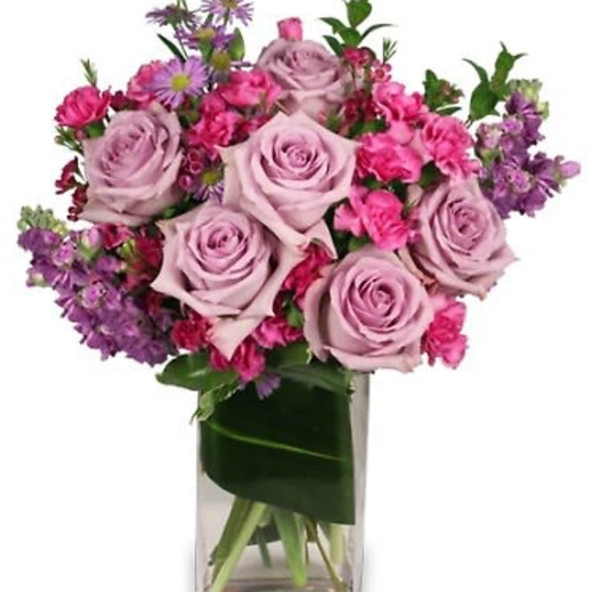 They'll love getting this luscious bouquet! Featuring lavender roses, fuchsia mini carnations