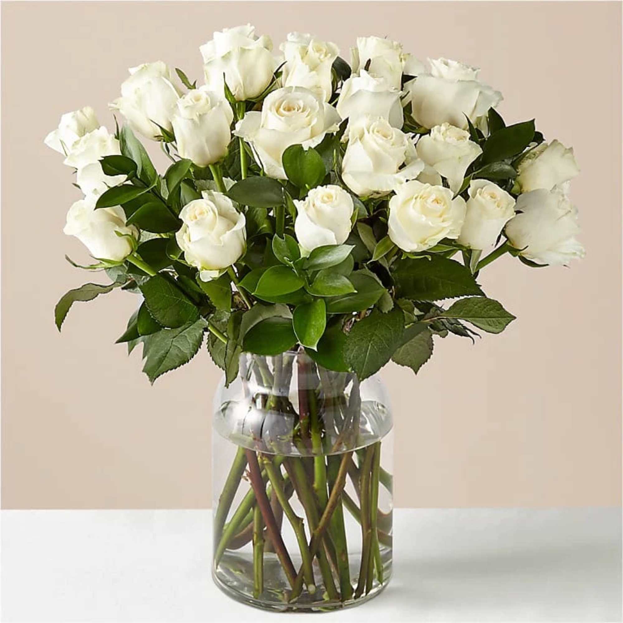 White roses arranged in a clear glass vase