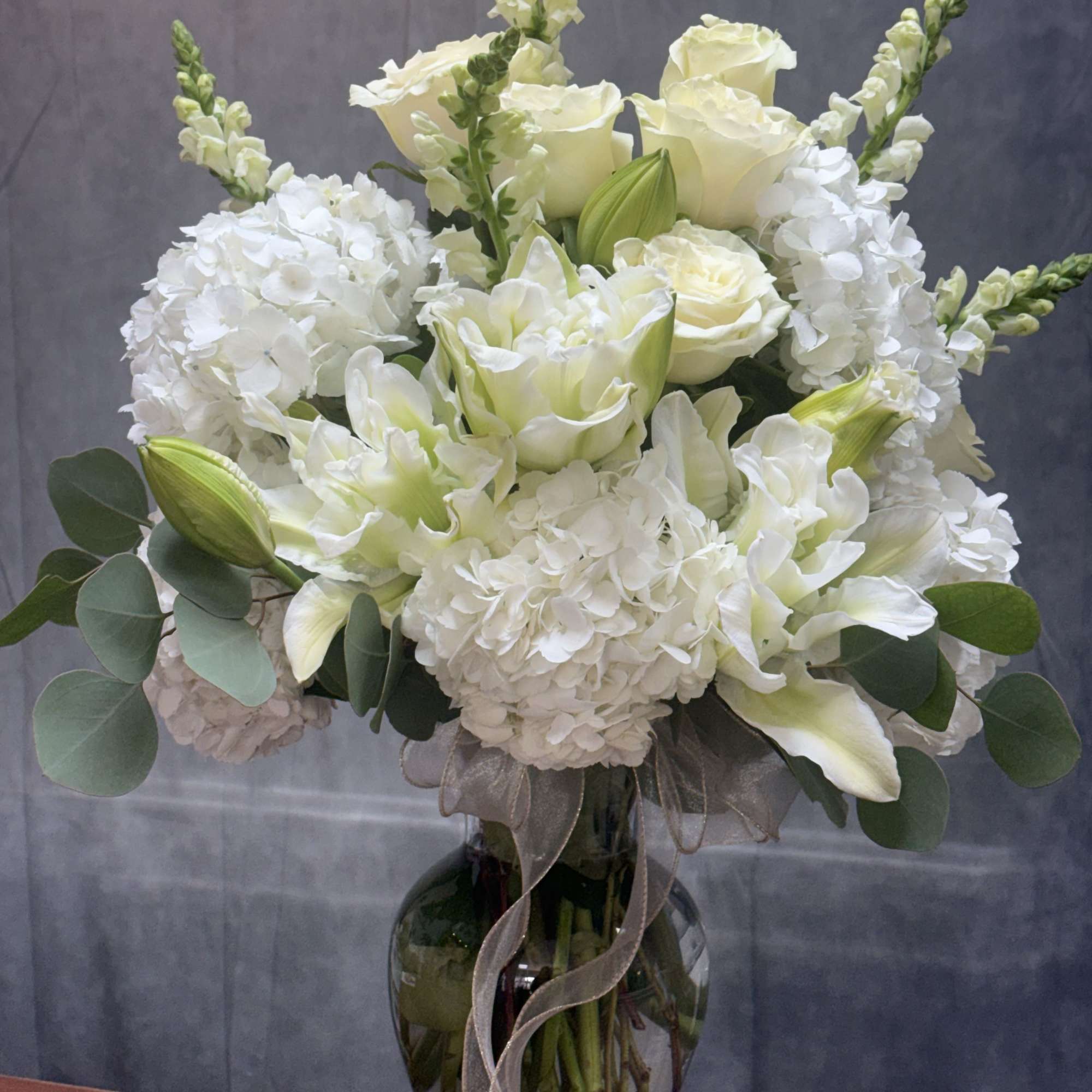 Pure Serenity is a graceful arrangement of white lilies , white roses