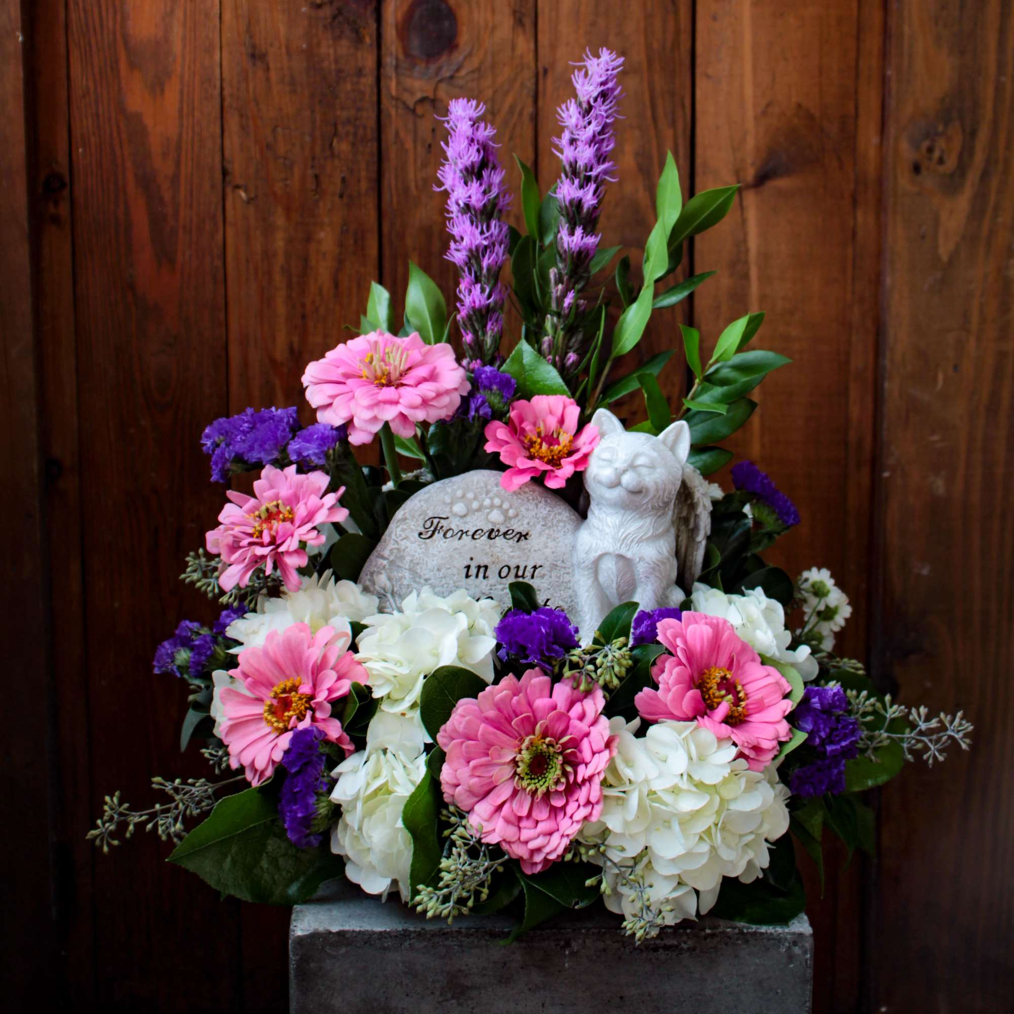 An arrangement in remembrance of your precious fur baby with a keepsake