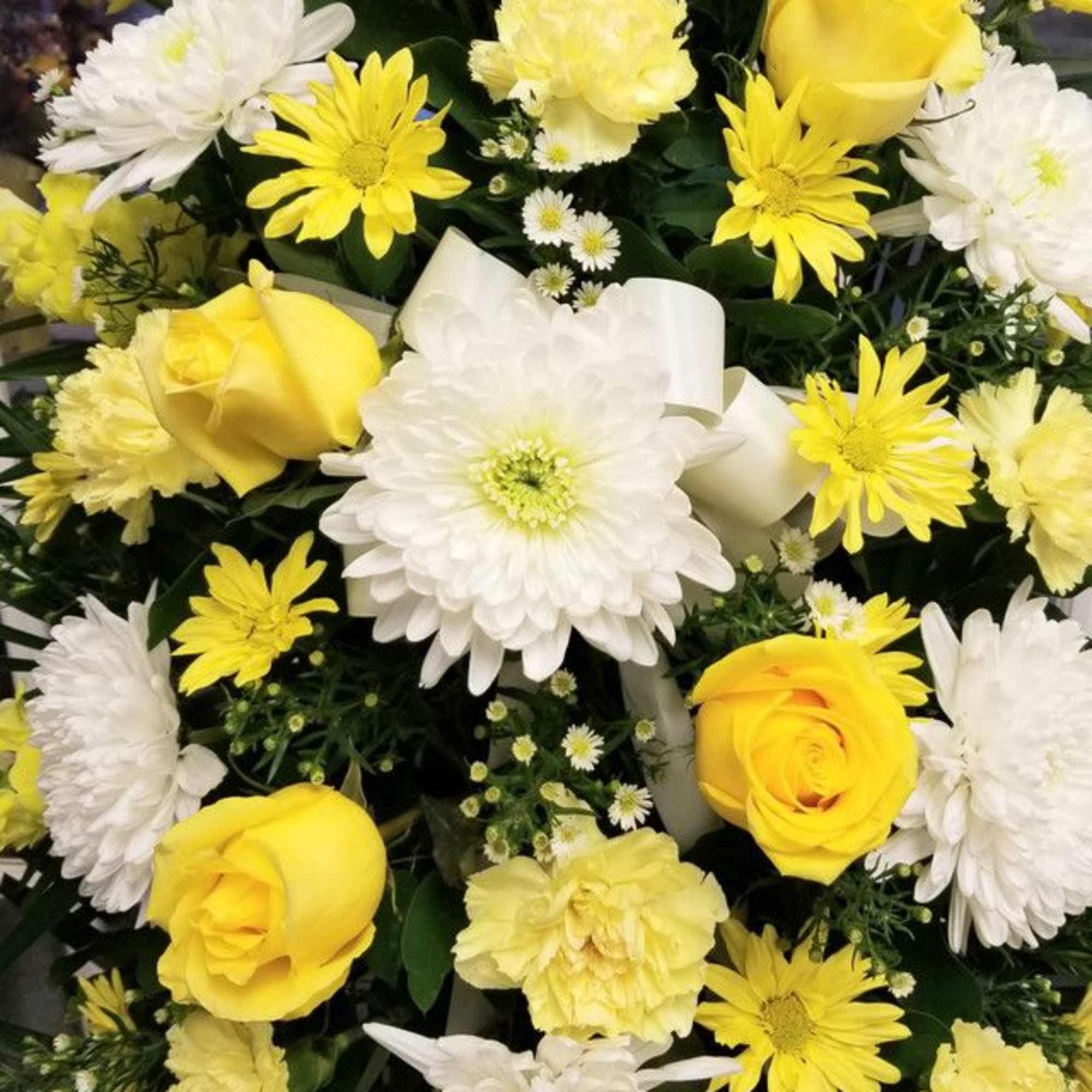 Bouquet of yellow roses and white daisies with a white ribbon