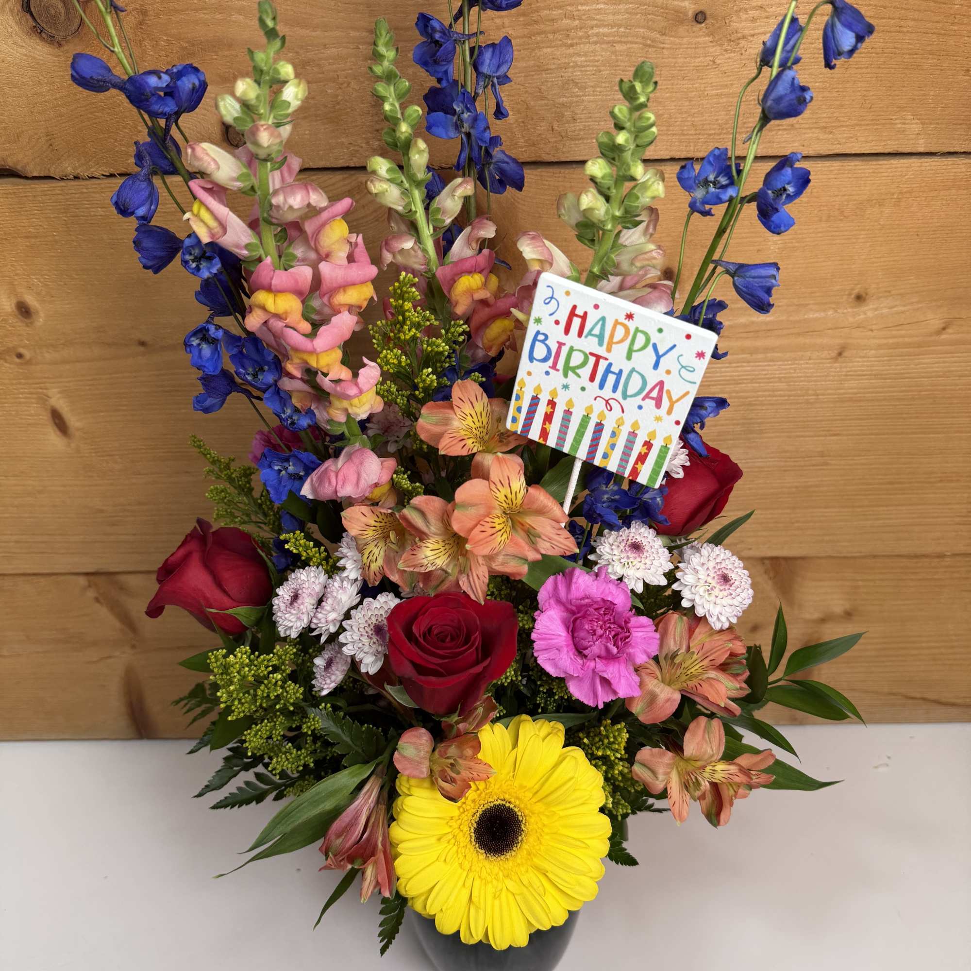 Colorful birthday bouquet with roses, gerbera daisy, and mixed blooms