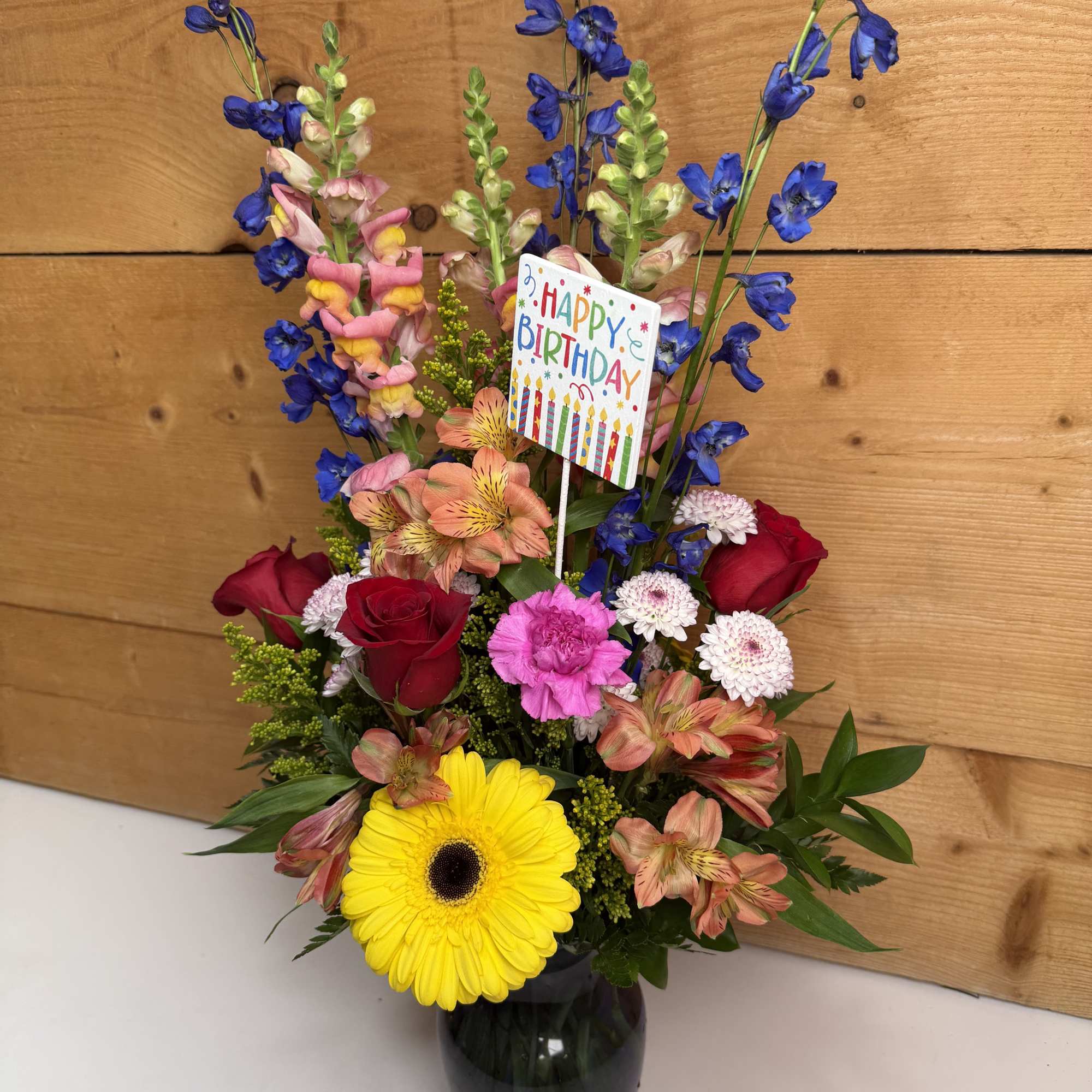 Mixed bouquet in a vase with a birthday card and bright flowers