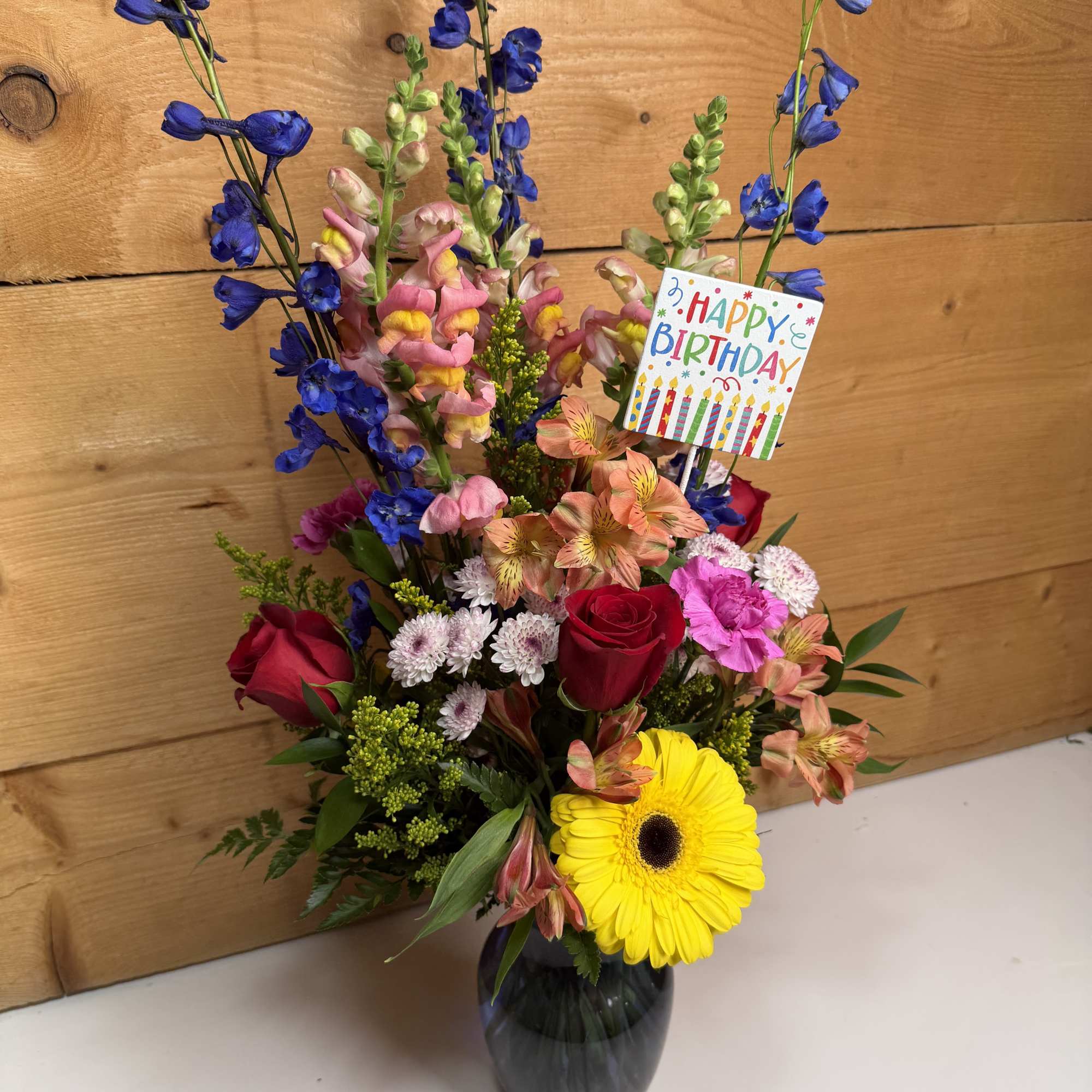 Mixed bouquet in a dark vase with a birthday card