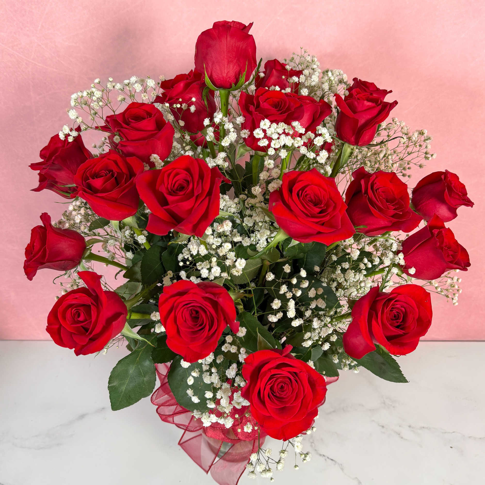 The Classic rendition of One Dozen Red Roses Vased by Savilles Florist