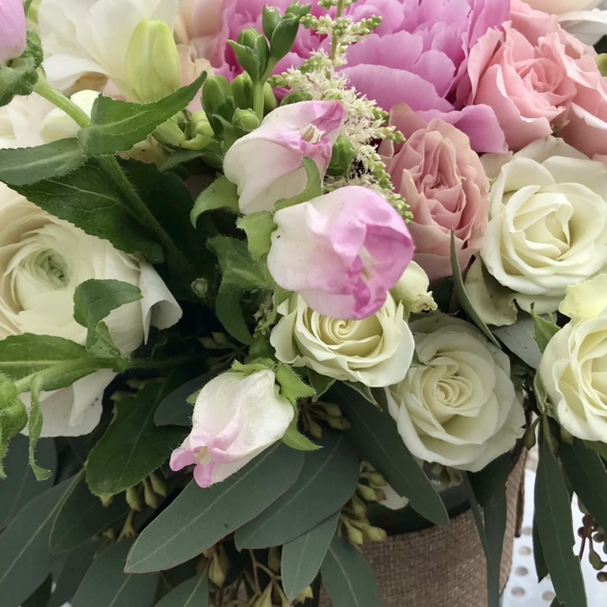 Bouquet of pink and white roses with a large pink peony
