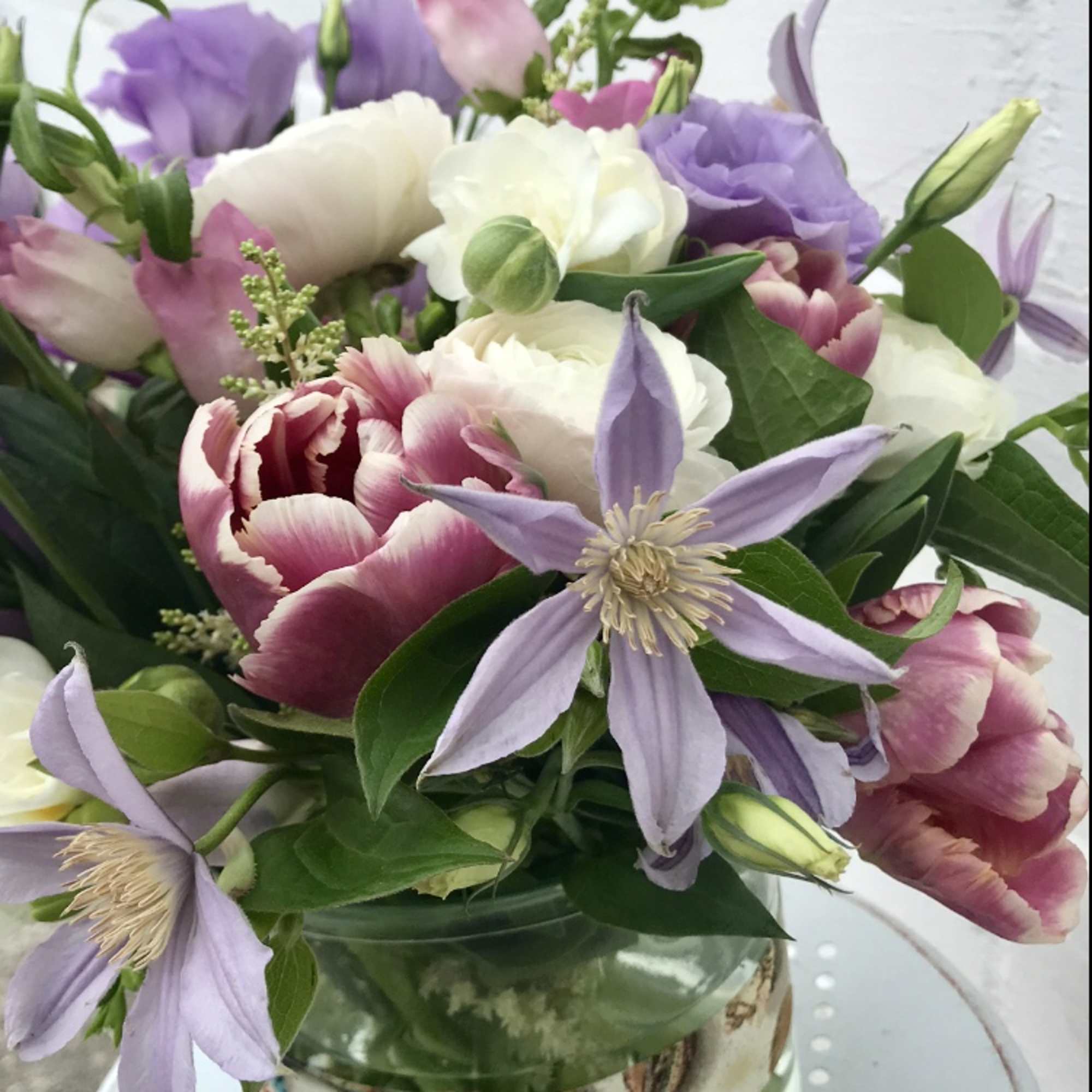 Bouquet of pink, white, and lavender flowers in a glass vase
